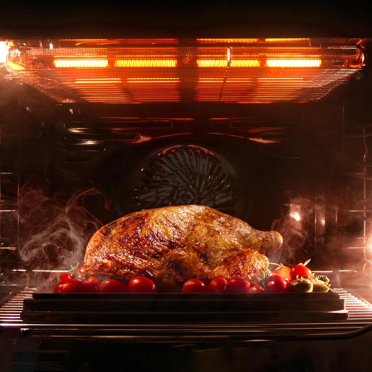 Whole roasted chicken and vegetables cooking inside the Cecotec oven.