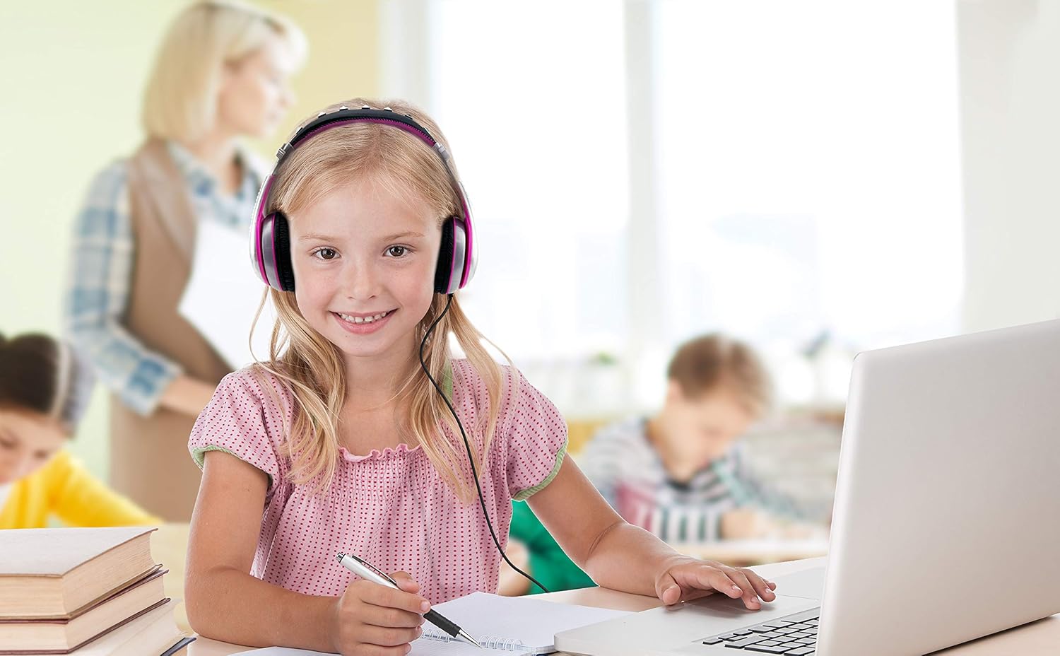 Girl wearing eKids LOL Surprise headphones while using a laptop for remote learning.
