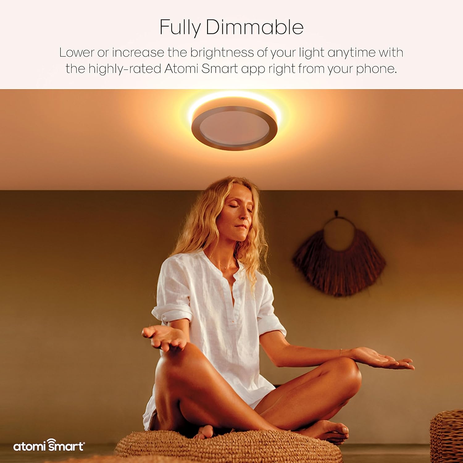 Woman meditating under a warm, dim light from the Atomi Smart Ceiling Light