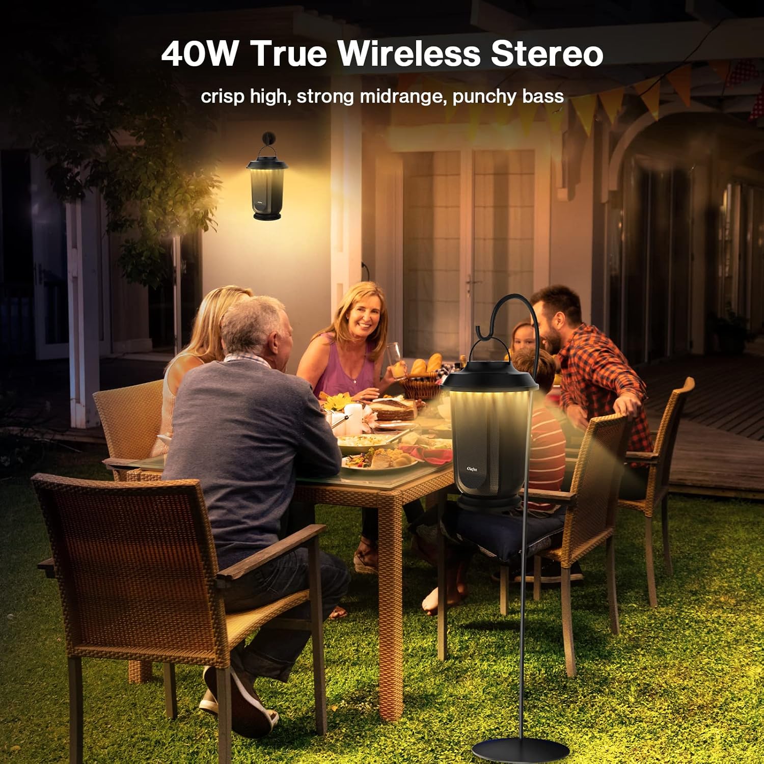 People enjoying music outdoors with an Olafus speaker on a stand, illustrating True Wireless Stereo sound.