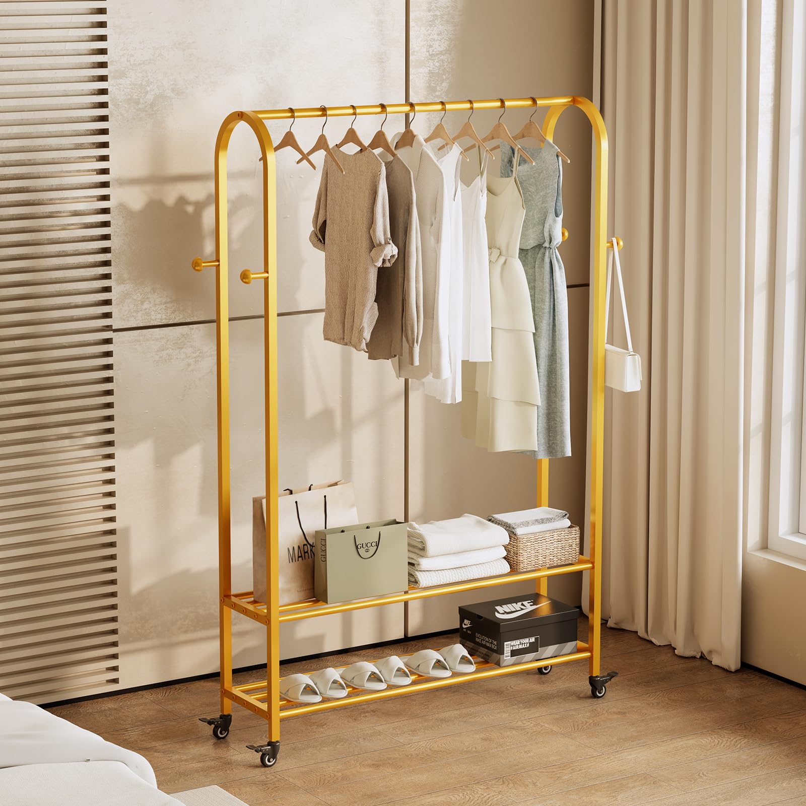 Kleiderständer auf Rollen 110 cm, Garderobenständer Metall mit 2 Ablagen und 4 Haken, Mobiler Kleiderständer mit Feststellbaren Rollen, Bogenförmiges Design, Robust & Elegant (Gold)