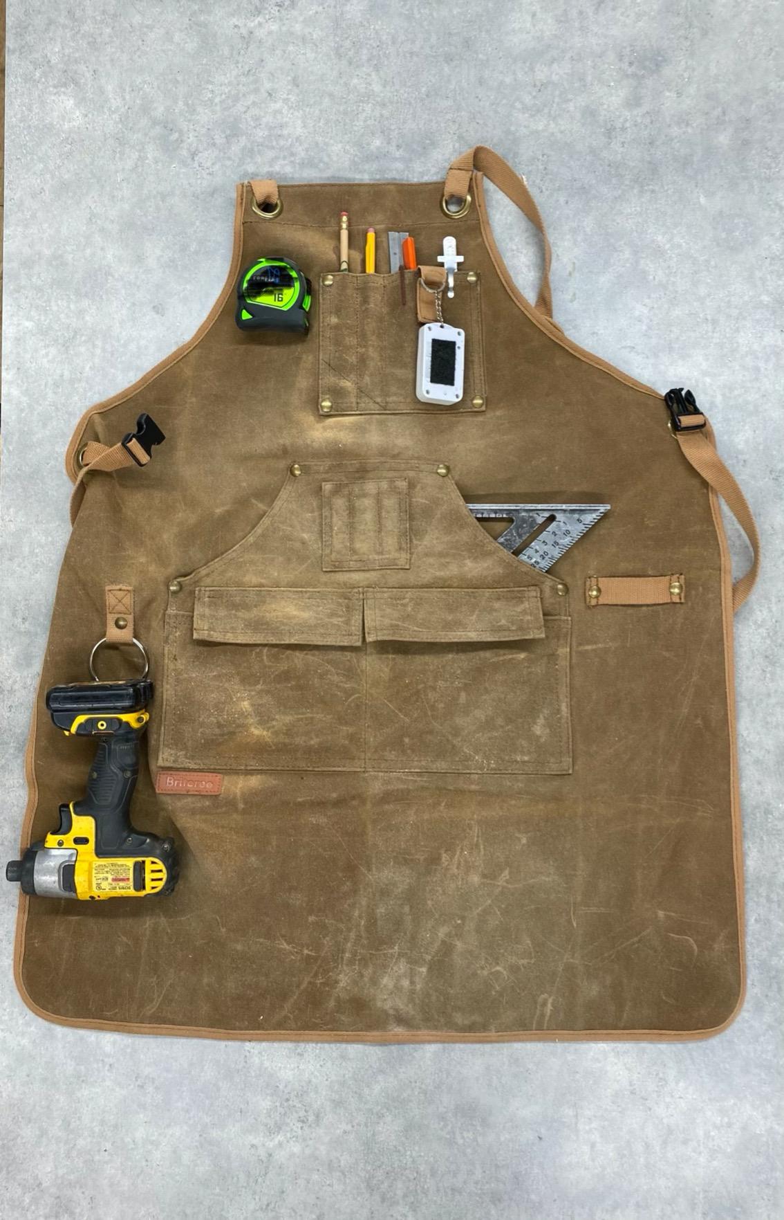 Briteree woodworking apron worn at a workbench, front view showing pockets and cross-back straps