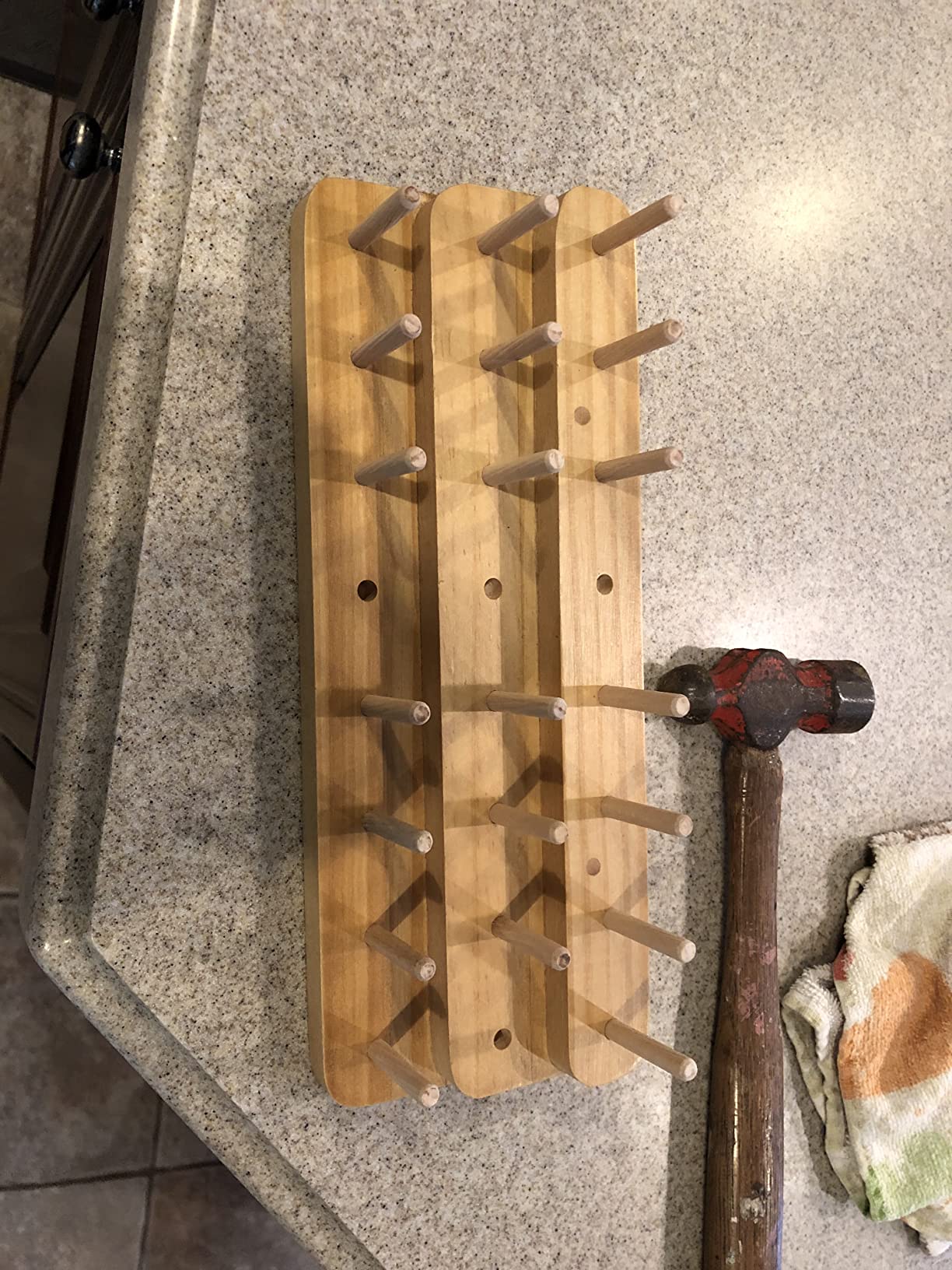 Riverruns thread spool stand mounted on wall with threads loaded