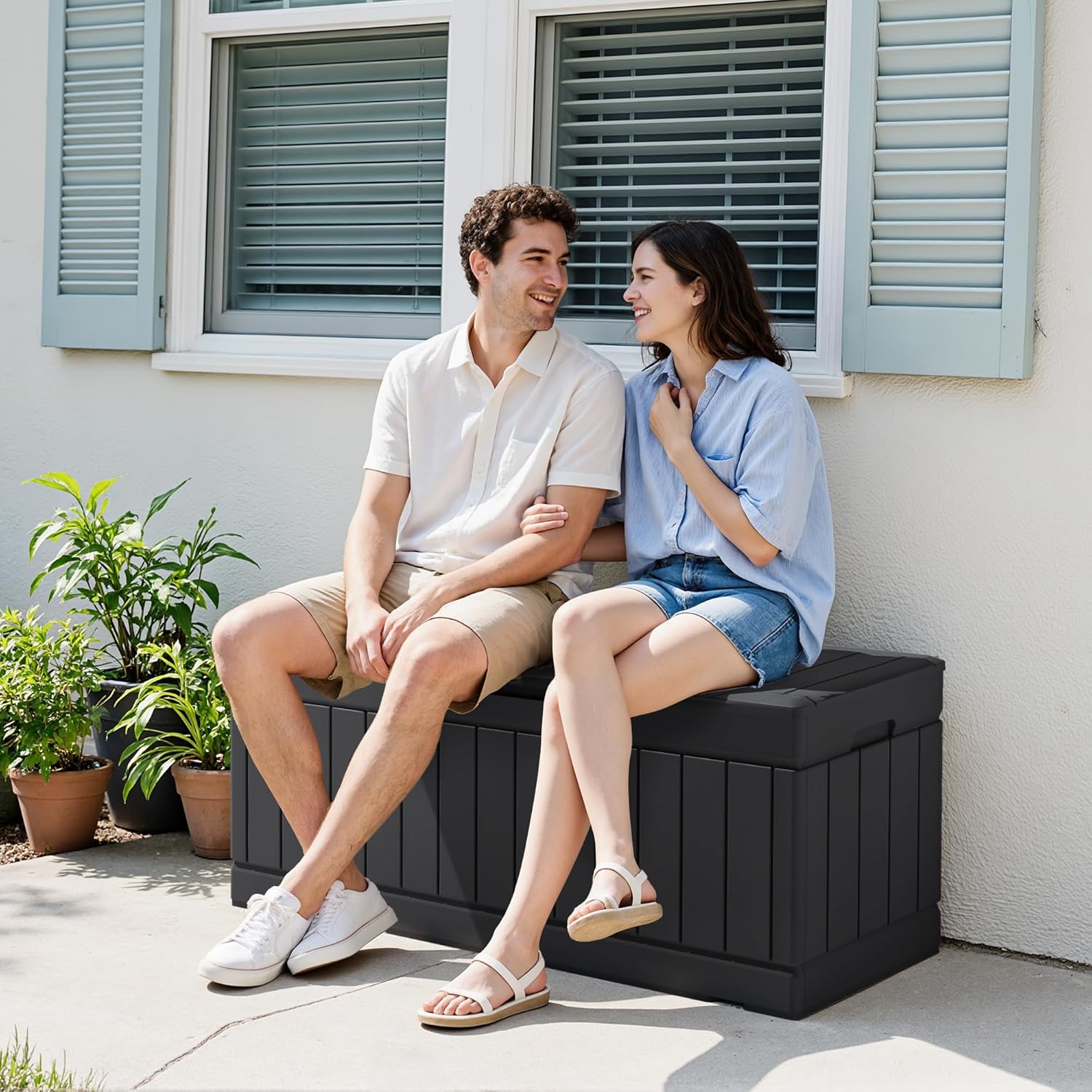 A person assembling the Devoko Deck Box, connecting side panels to the base.