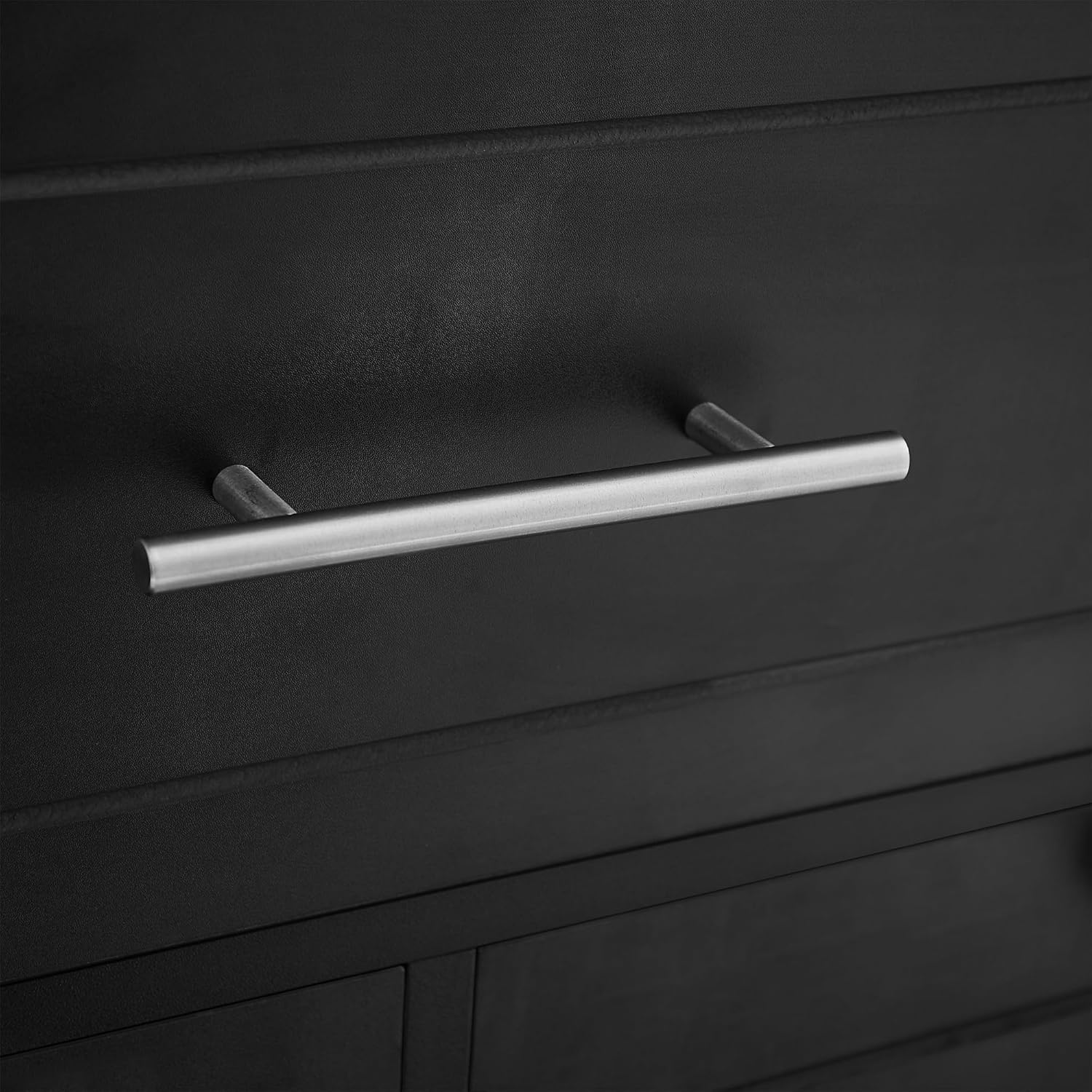 Close-up of the silver metal handle on the pull-out drawer of the Polibi cabinet.
