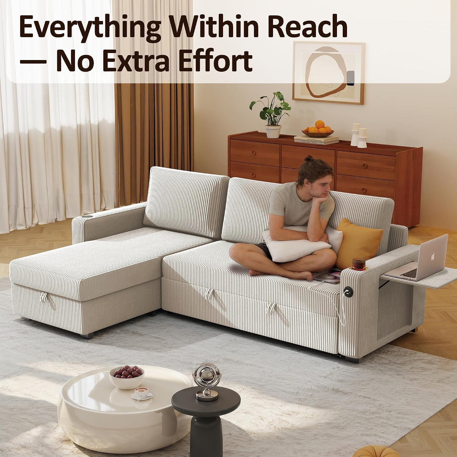 A person using the Ball & Cast sectional sofa, with a laptop on the foldable side table and a phone charging via the USB port, demonstrating the convenience features.