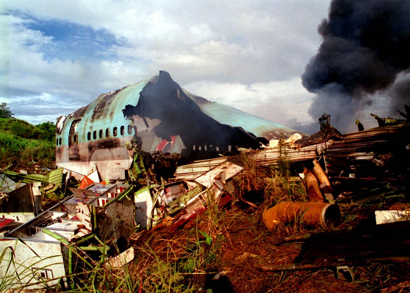 Home Comforts Laminated Poster As noon Aug. 6, 1997, approaches, Wreckage Korean Airlines Flight 801 Still smolders. U.S. Nav