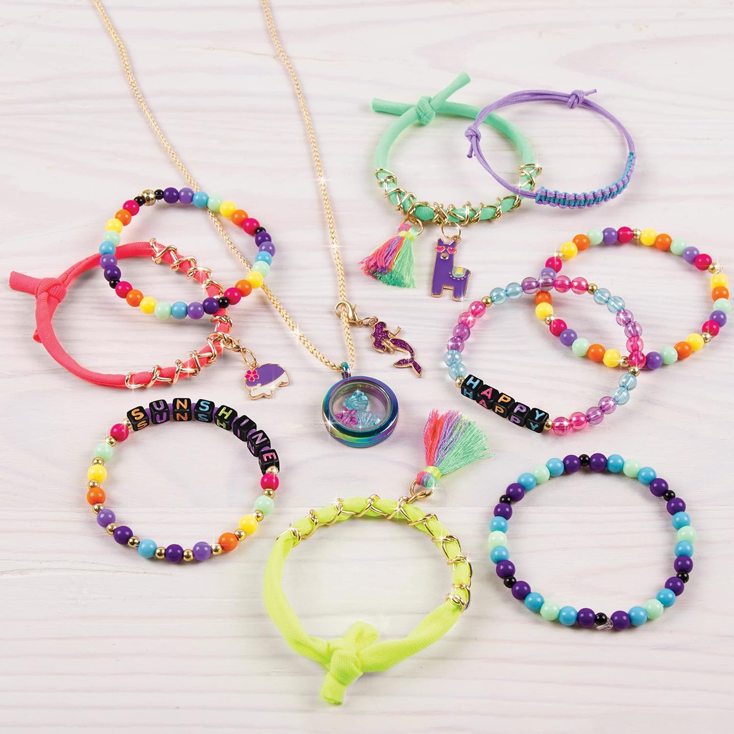 A collection of colorful, handmade bracelets and necklaces created using the Make It Real Mega Jewelry Studio kit.