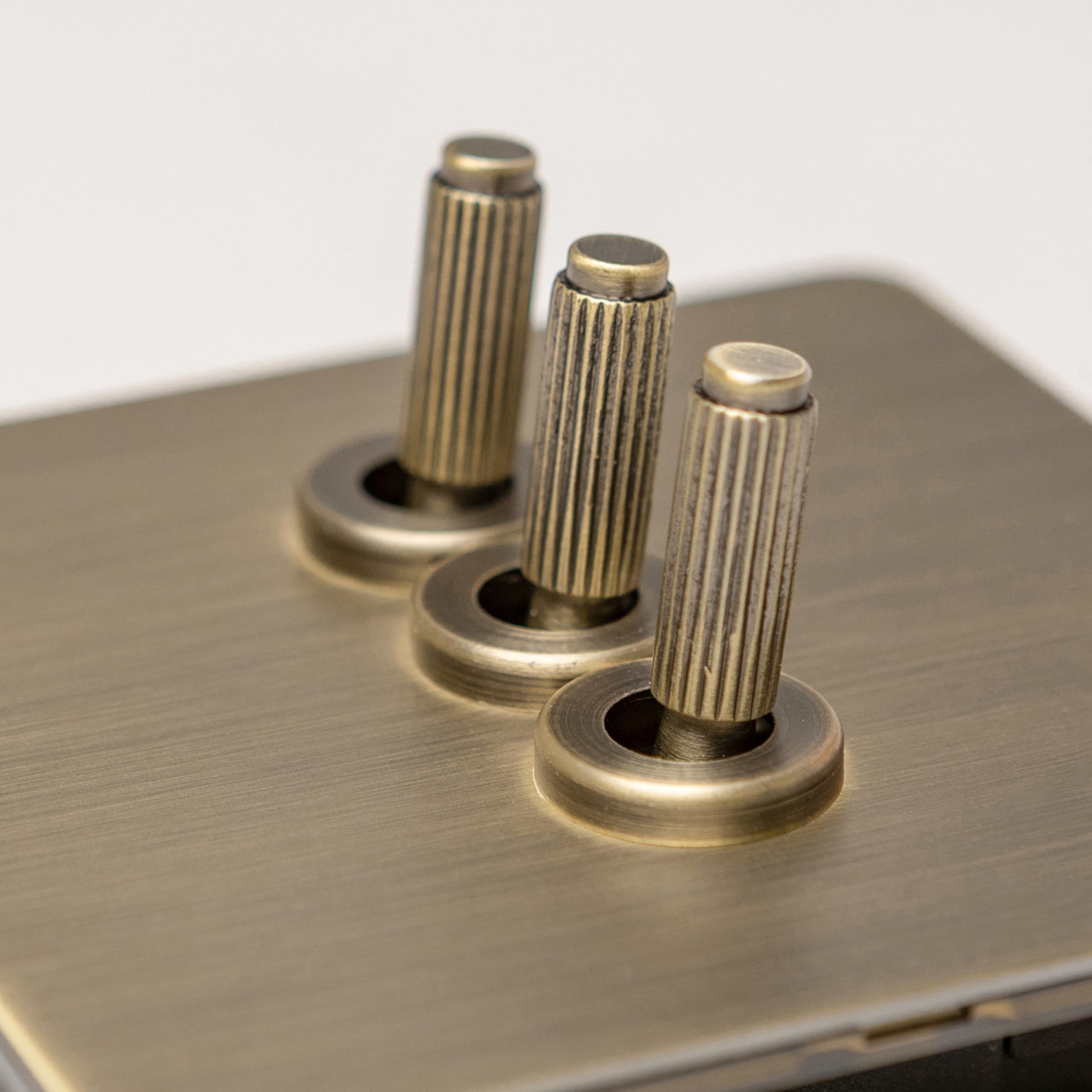 Antique Brass Straight Knurled Switches and Sockets (3 gang 2 way Toggle) — image 1