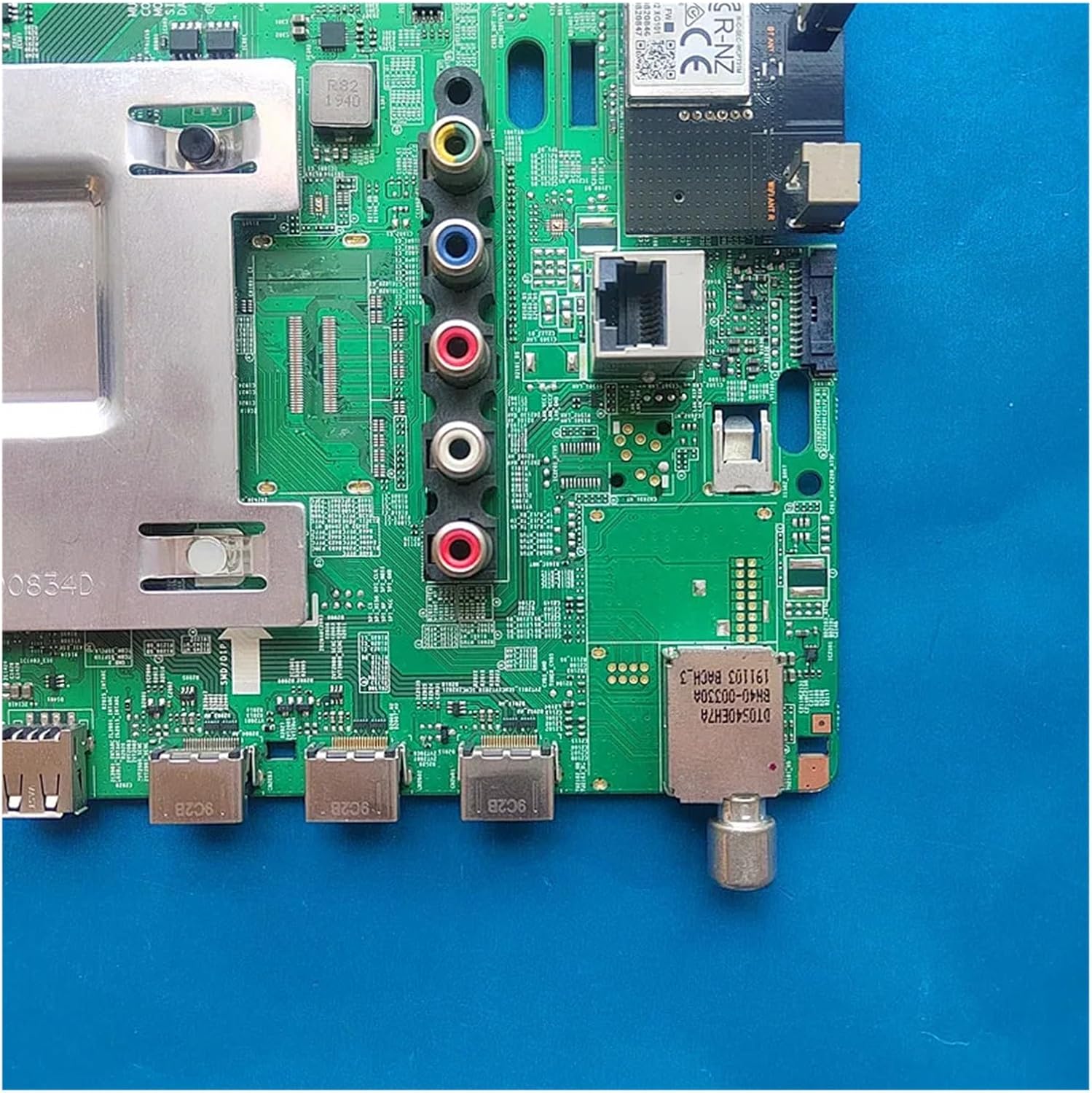 Close-up of the main board's input/output ports including HDMI, USB, Ethernet, RCA, and antenna connectors