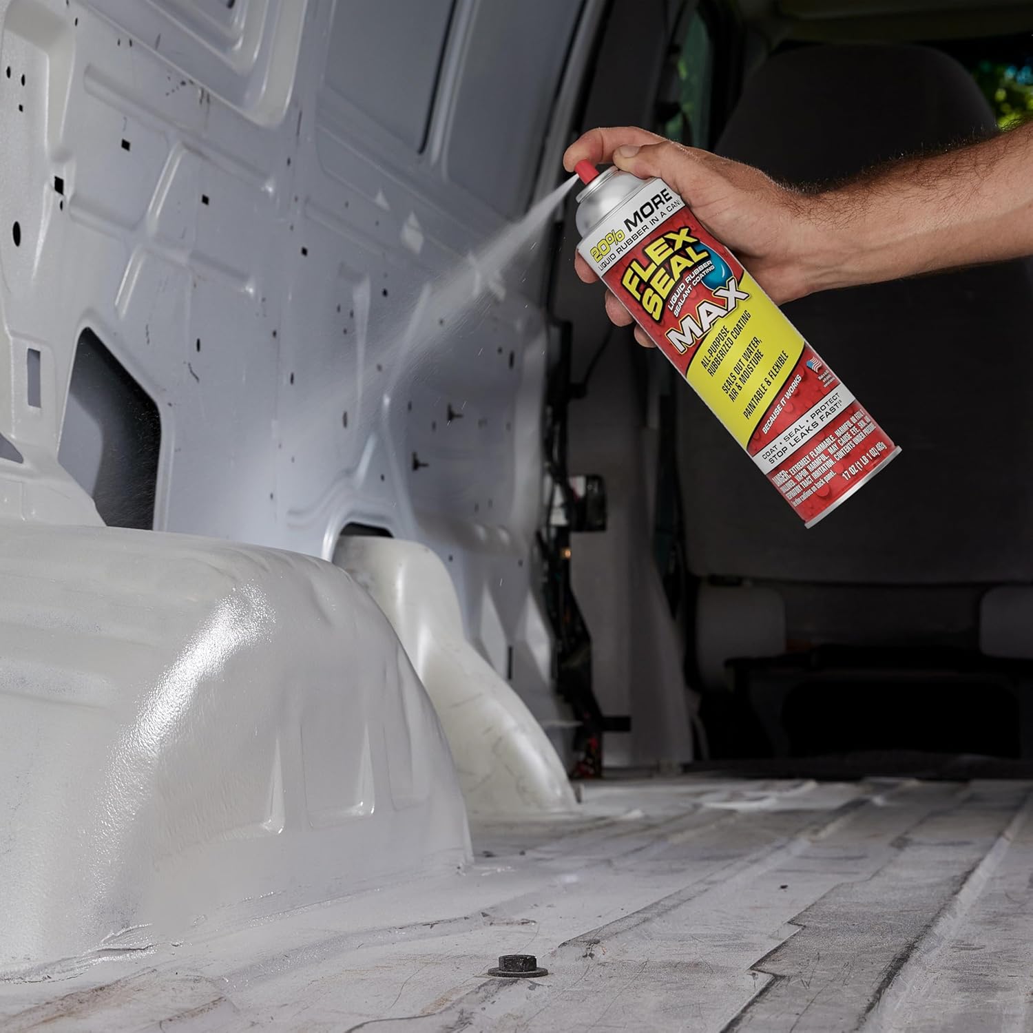 Person spraying Flex Seal MAX inside a van