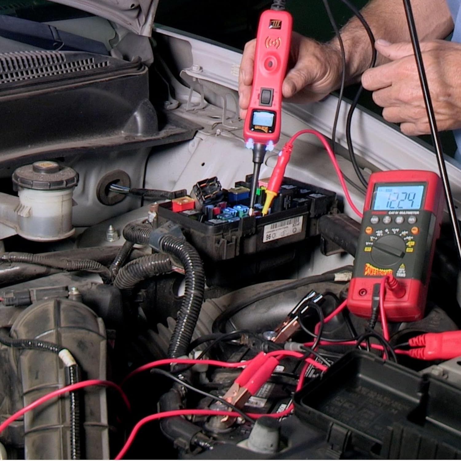 Mechanic using Power Probe 3 to test an automotive fuse box
