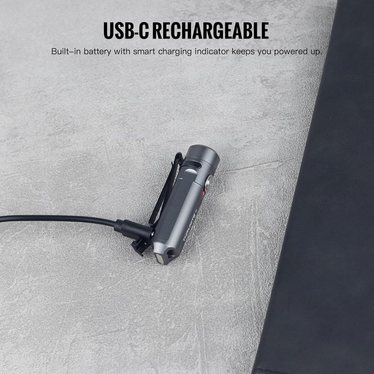 ThruNite Ti Mini Flashlight connected to a USB-C charging cable, with the charging indicator visible.