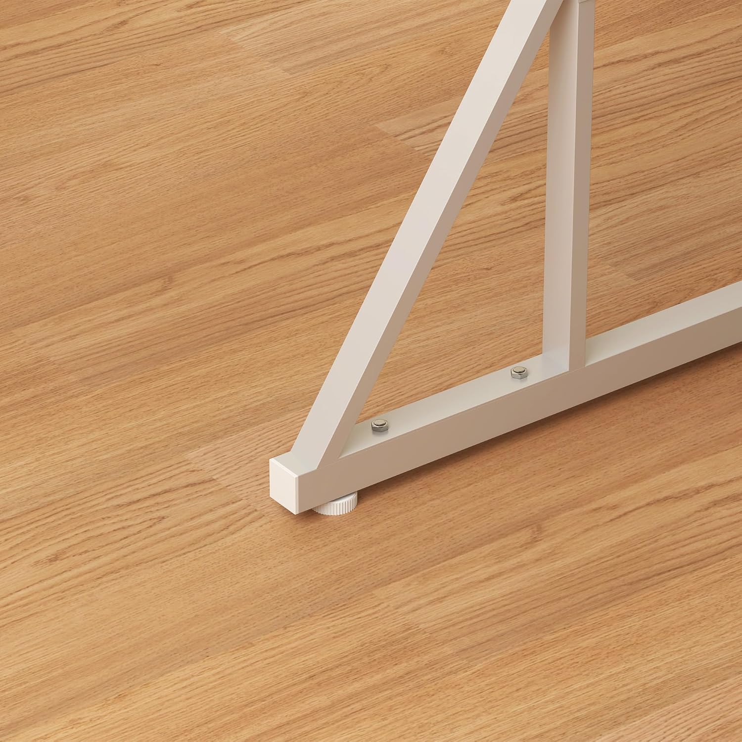 Close-up of the adjustable foot pads on the table's trestle base.