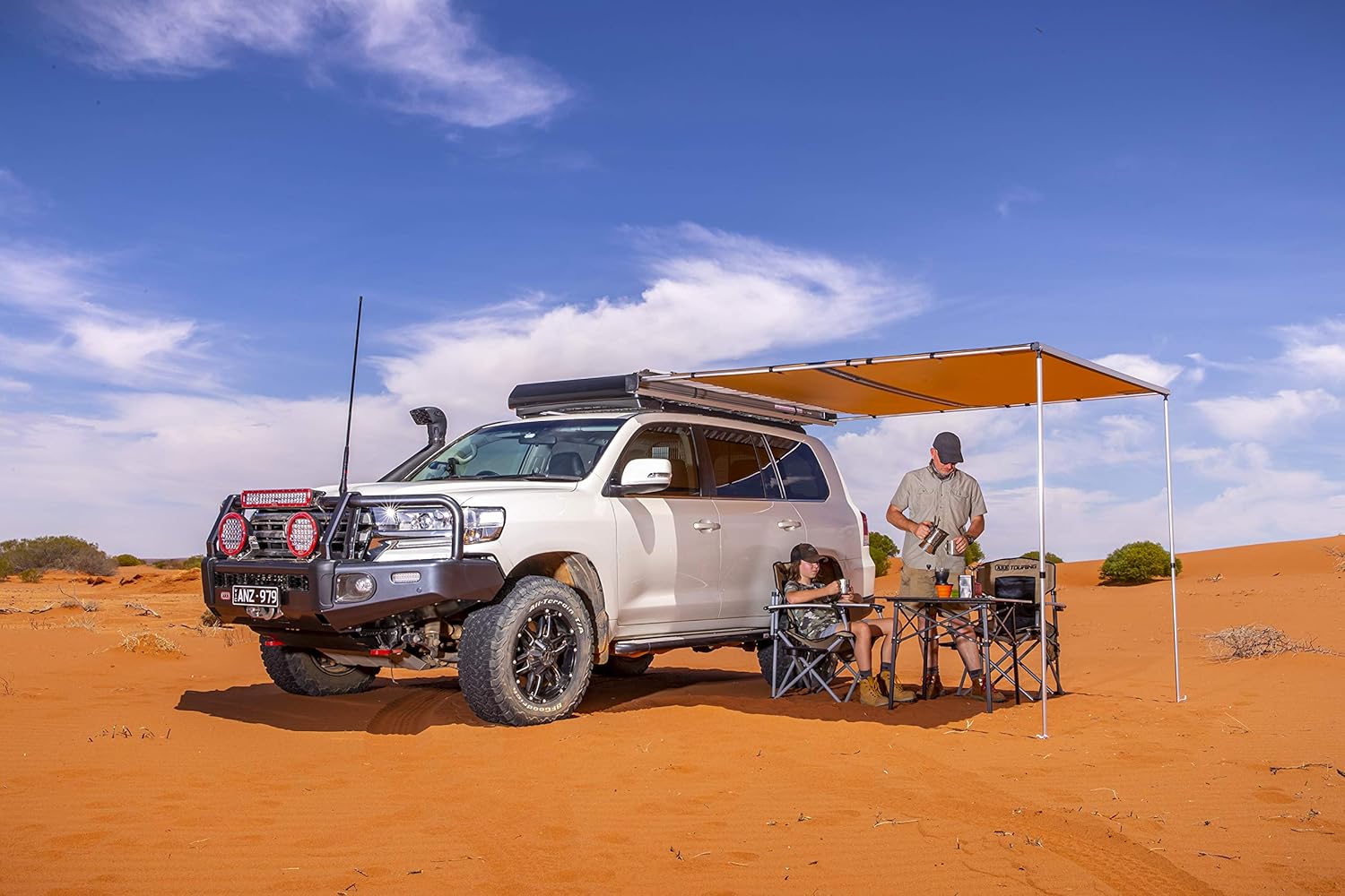 ARB Awning deployed from a 4x4 vehicle in a desert landscape.