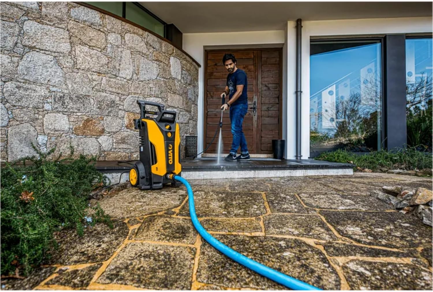 Person using VITO High Pressure Washer to clean a patio