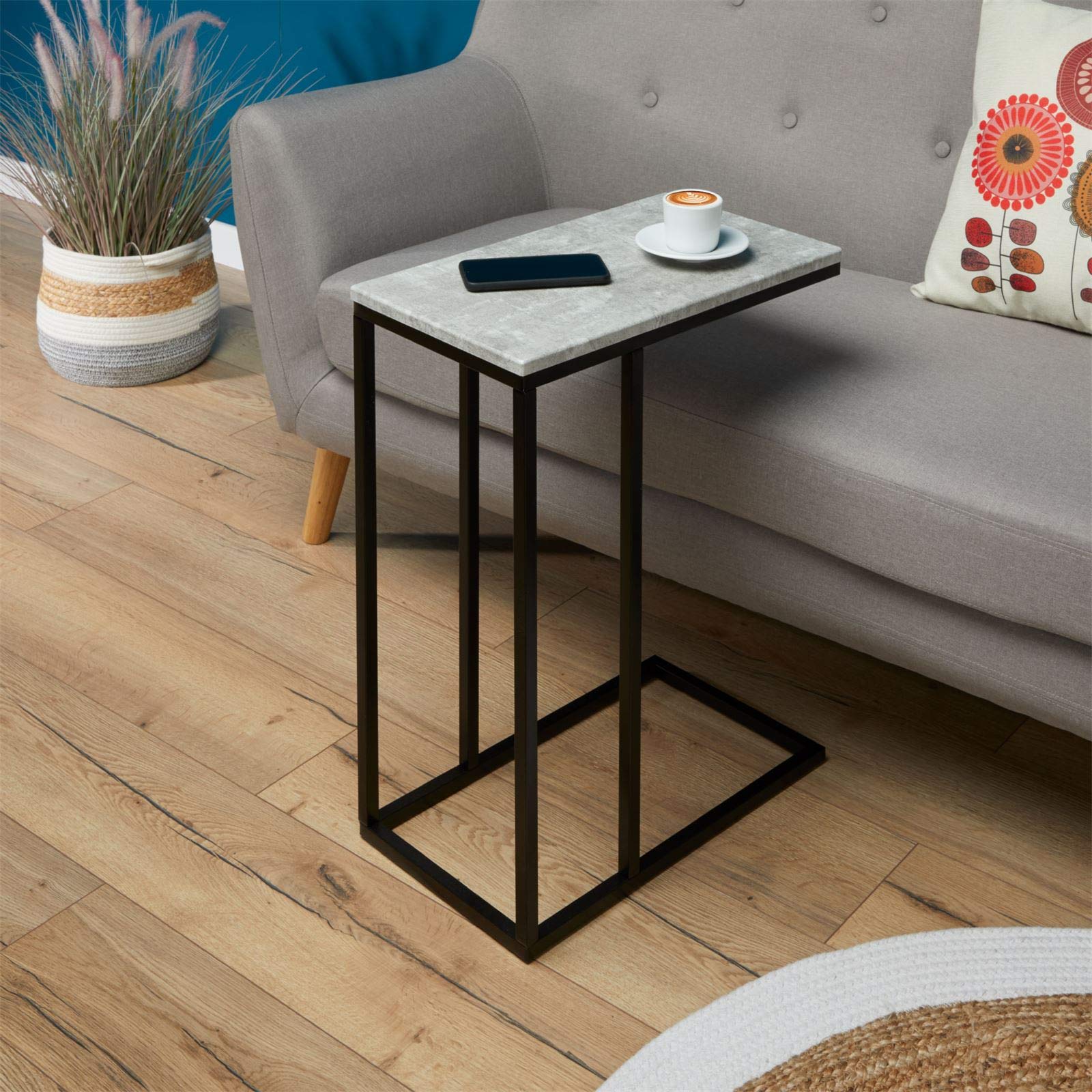 IDIMEX Mesa Auxiliar Debora, Práctica Mesa De Salón En Forma De C, Bonita Mesa De Centro Rectangular Con Aspecto De Hormigón, Elegante Mesa De Sofá Con Estructura De Metal En Color Negro