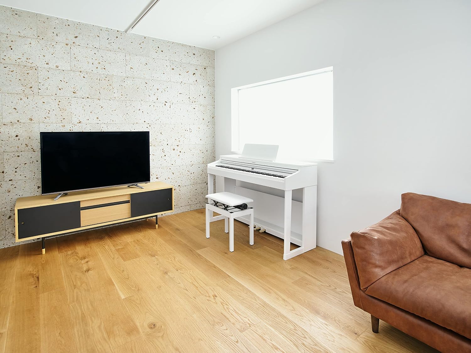 Roland RP701-WH Digital Home Piano placed in a modern living room setting.