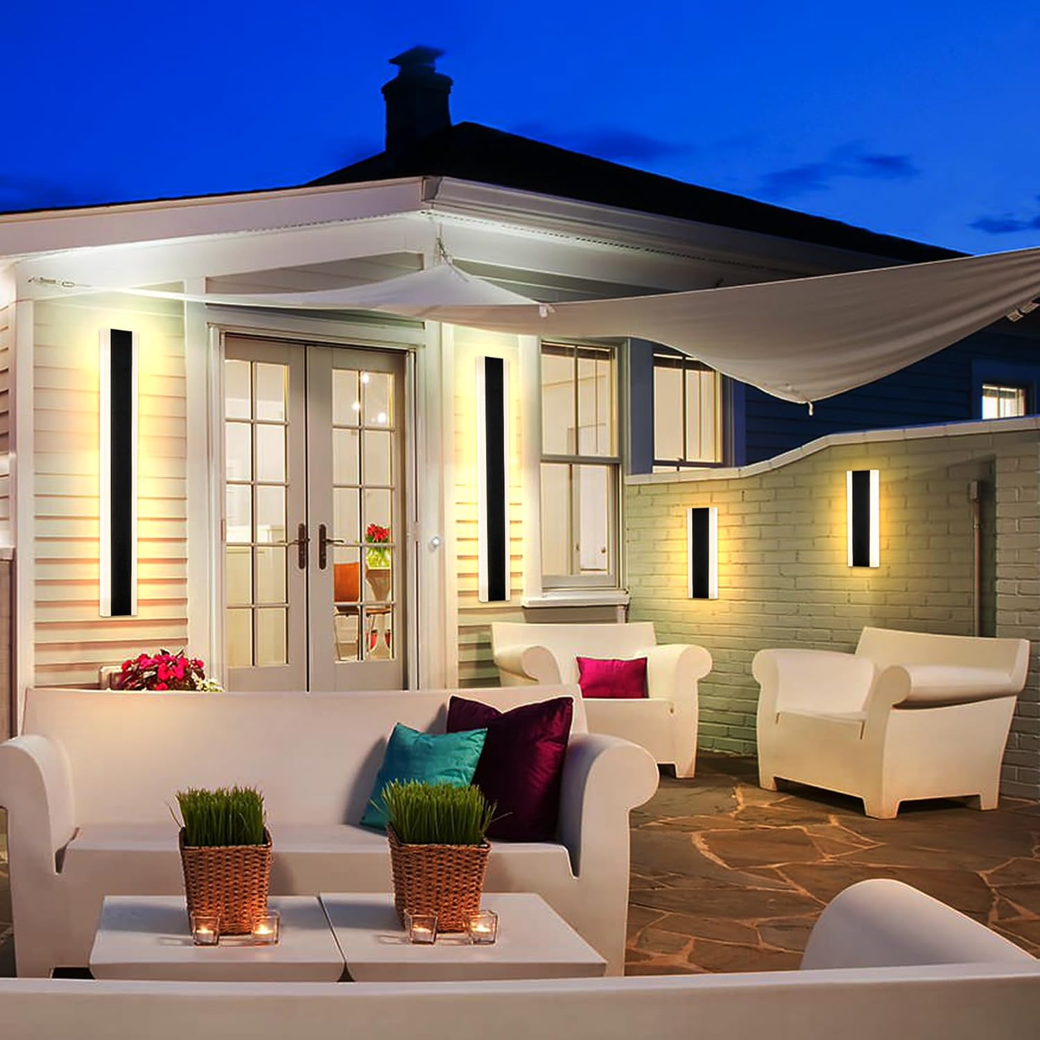 YCMGEAD LED wall sconces installed on an outdoor patio wall, providing warm ambient lighting.