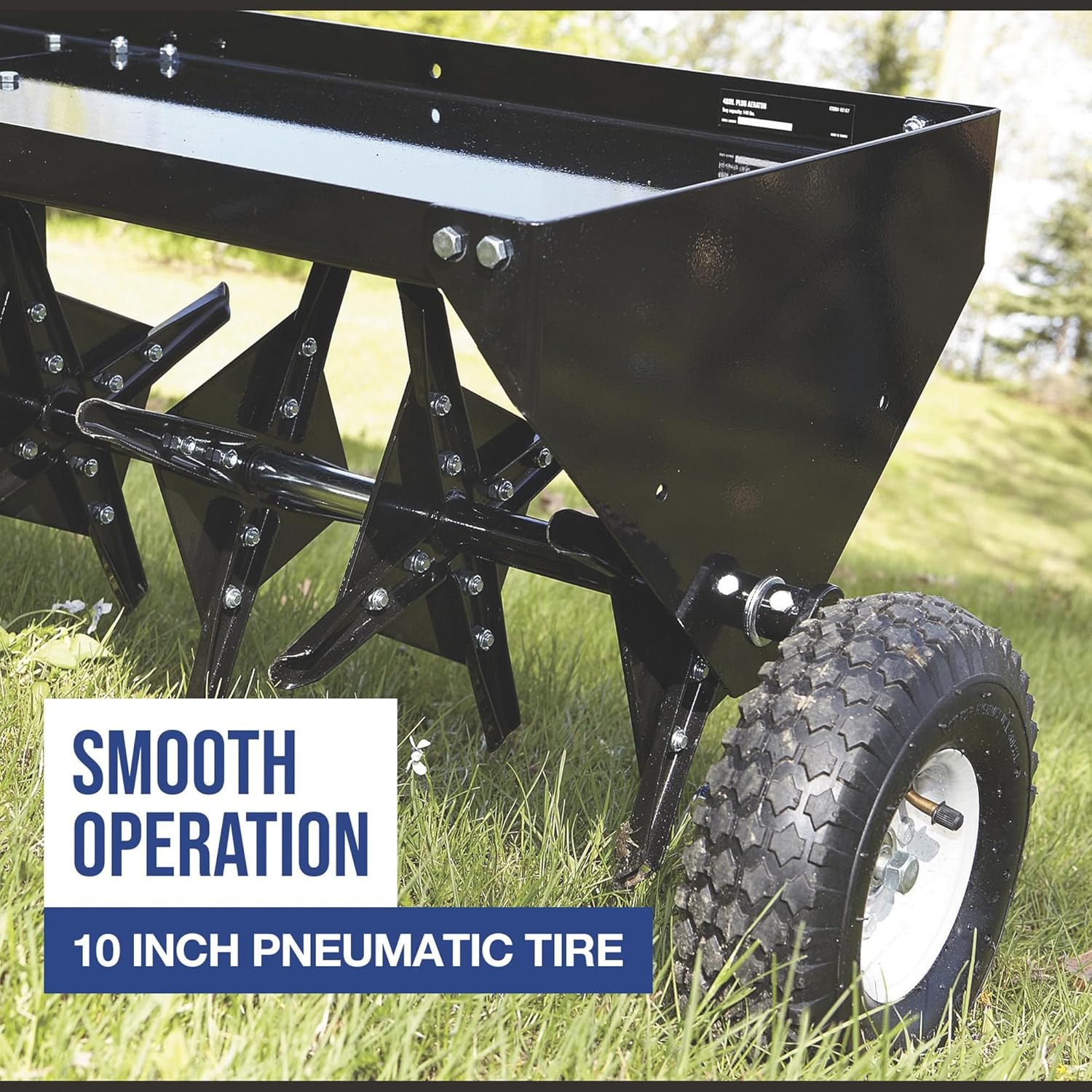 Close-up of the aerator's 10-inch pneumatic tire and coring plugs, indicating smooth operation.