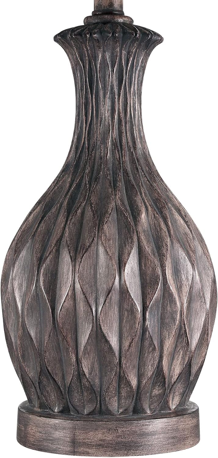 Close-up of the carved painted brown resin base of the Craftmade Table Lamp.