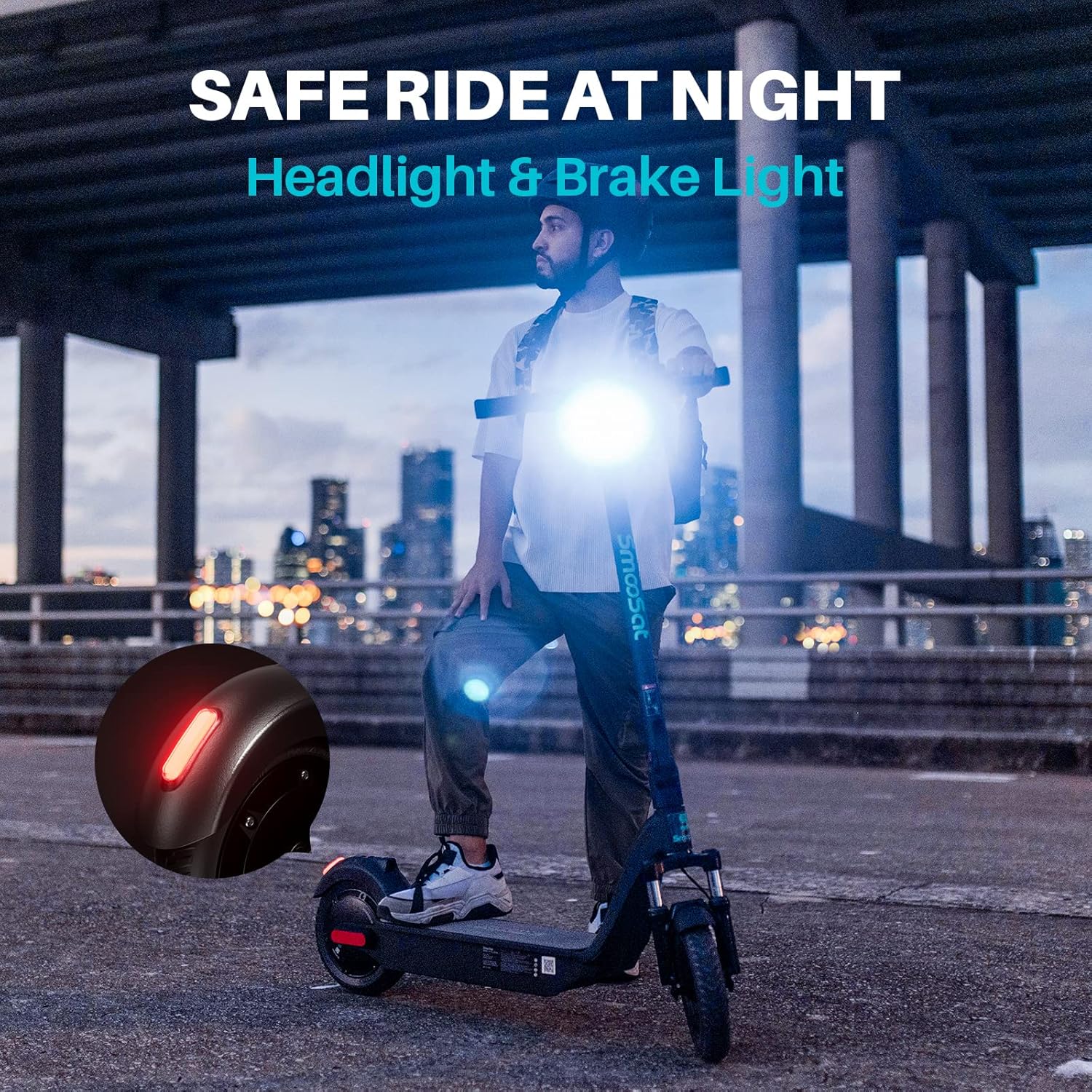 SmooSat MAX scooter with its headlight and brake light illuminated at night