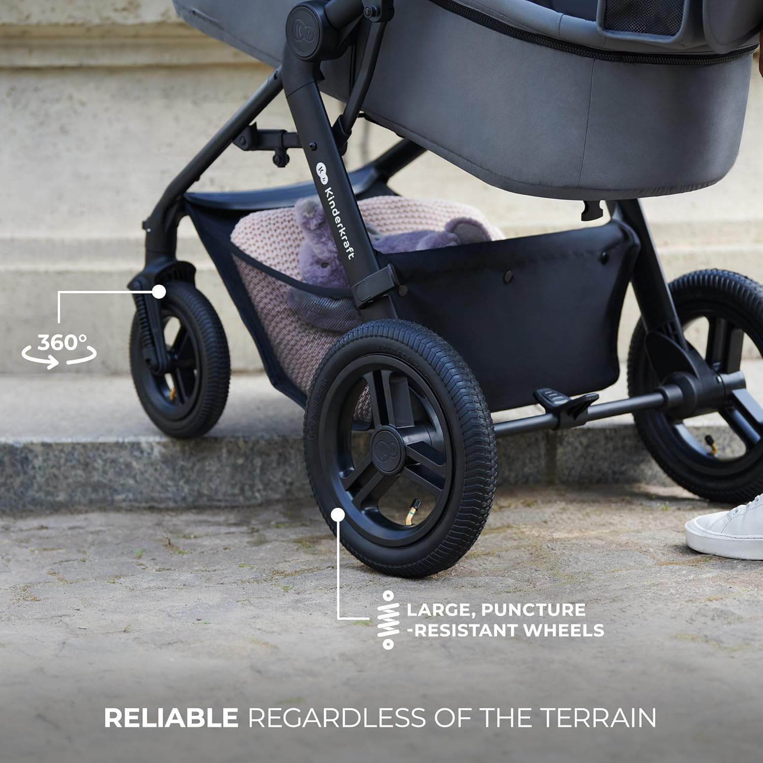 Close-up of the large, puncture-resistant wheels of the Kinderkraft MOOV2 AIR pram, highlighting their robust design and shock absorption.