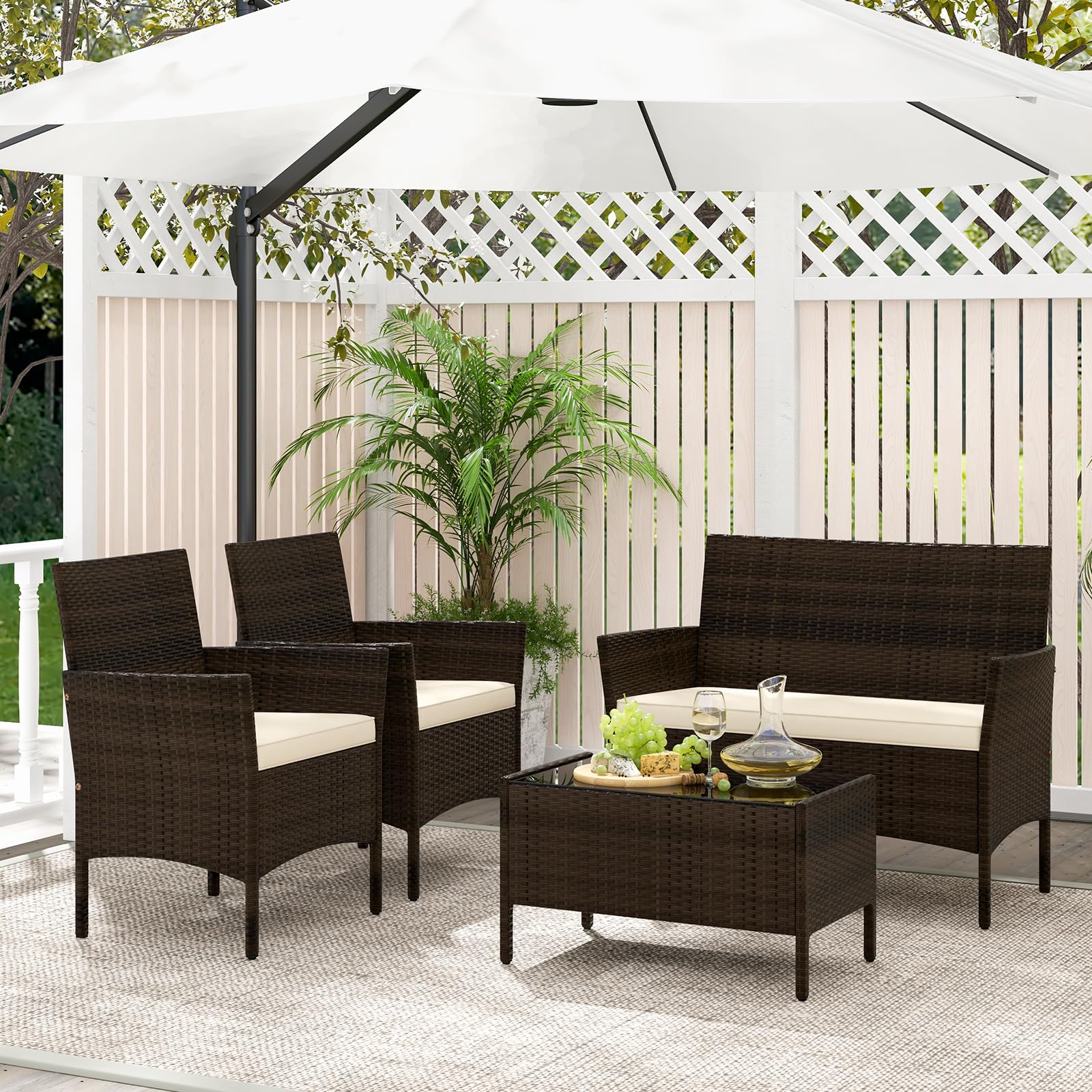 COSTWAY Set di Salotto da Giardino in Rattan 4 Pezzi, Set Mobili da Esterno in Vimini con Cuscini Morbidi, Divanetto e Poltrona con Tavolo in Vetro Temperato per Giardino e Veranda (Marrone)