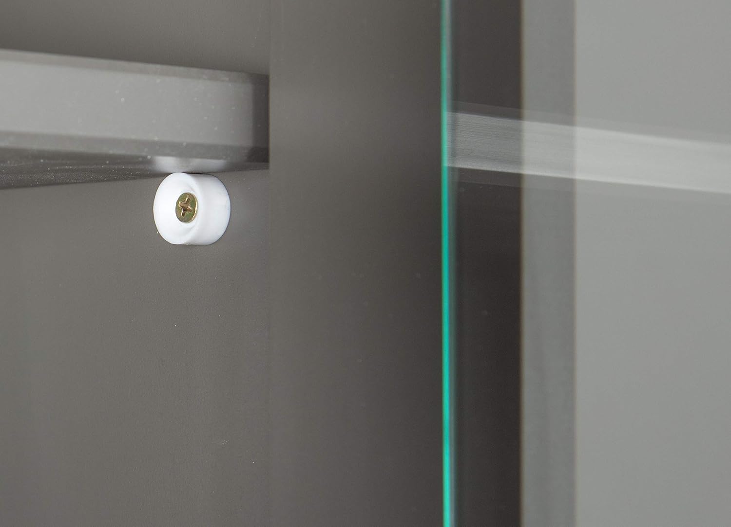 Close-up of a roller mechanism for a sliding glass door on the Inter Link Buffet, showing the small white wheel and its track.