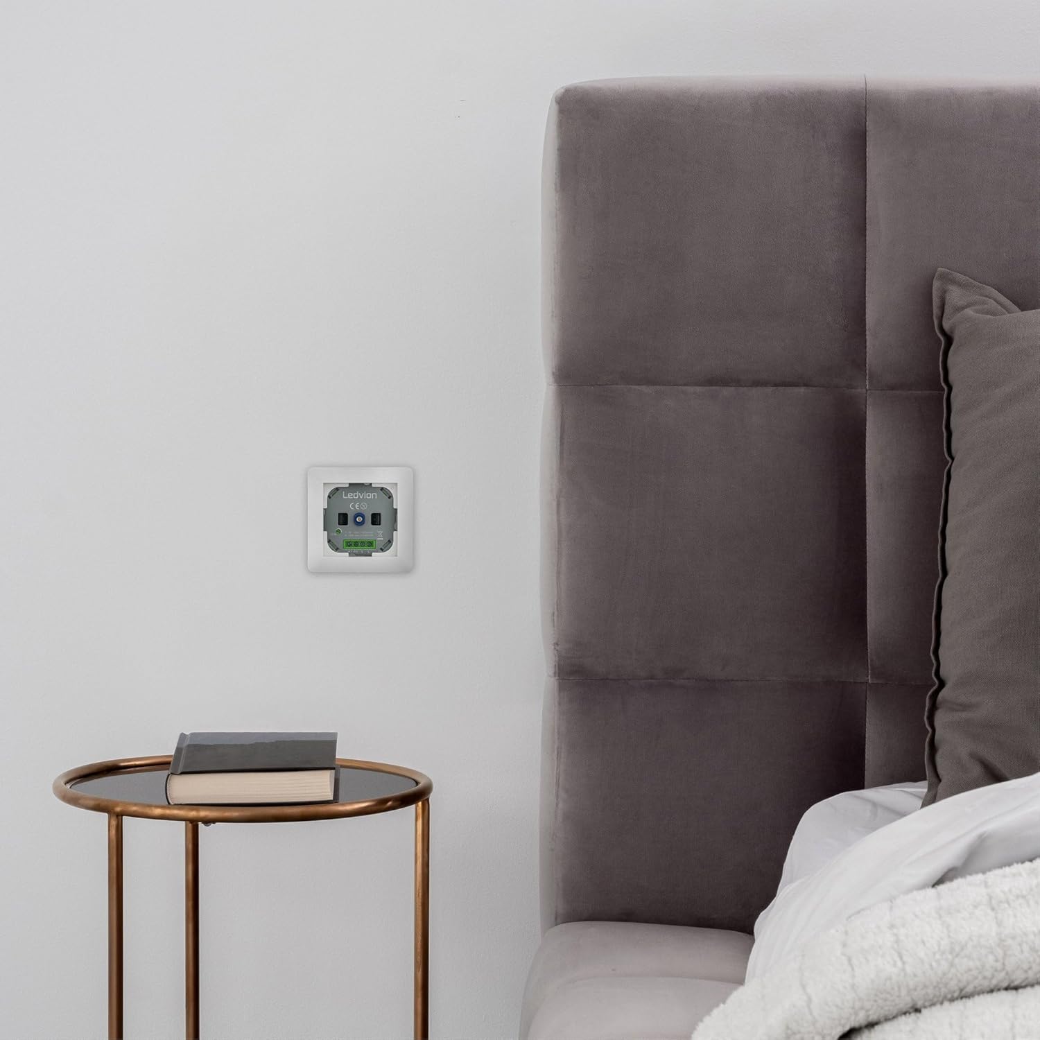 Ledvion LED Dimmer installed in a wall next to a bed