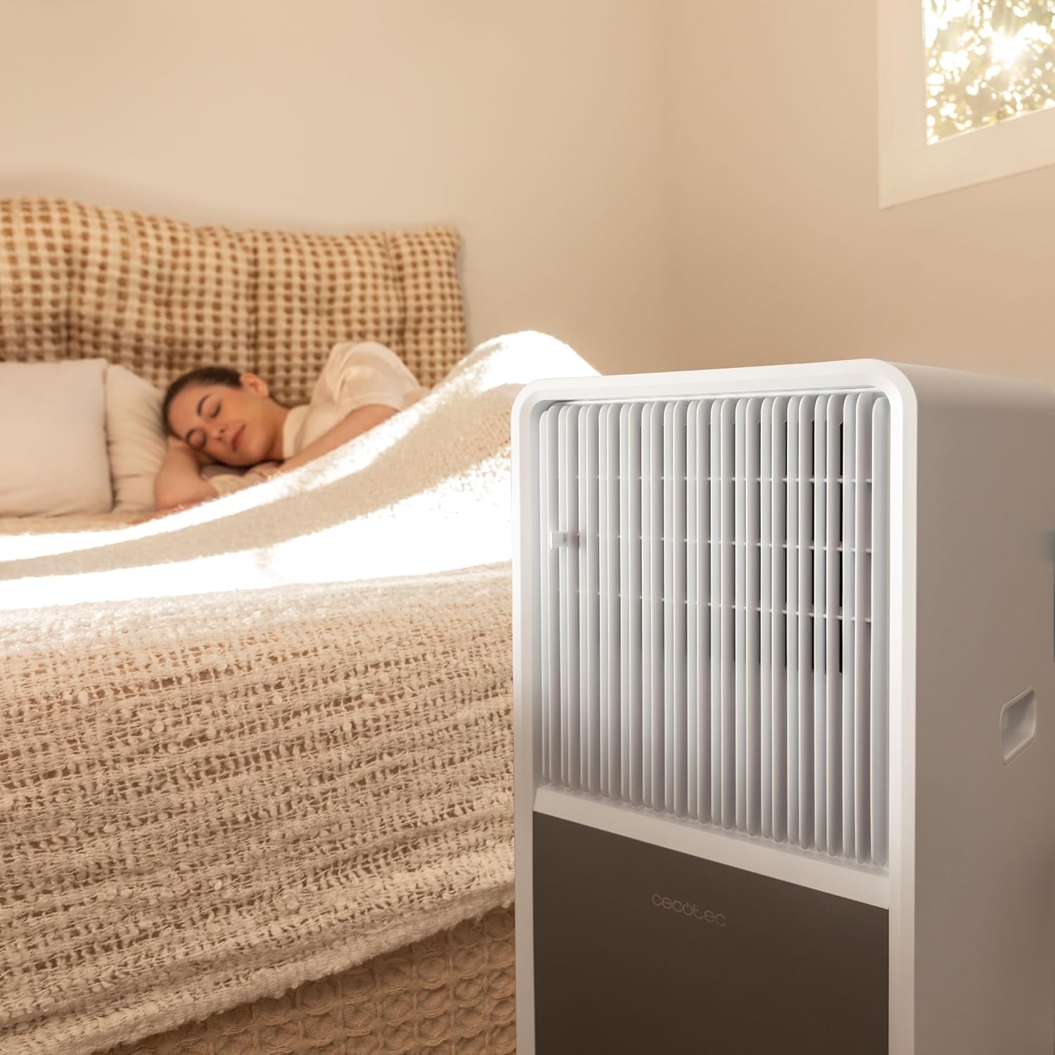 Cecotec ForceClima 9150 Style Portable Air Conditioner operating in a bedroom while a person sleeps