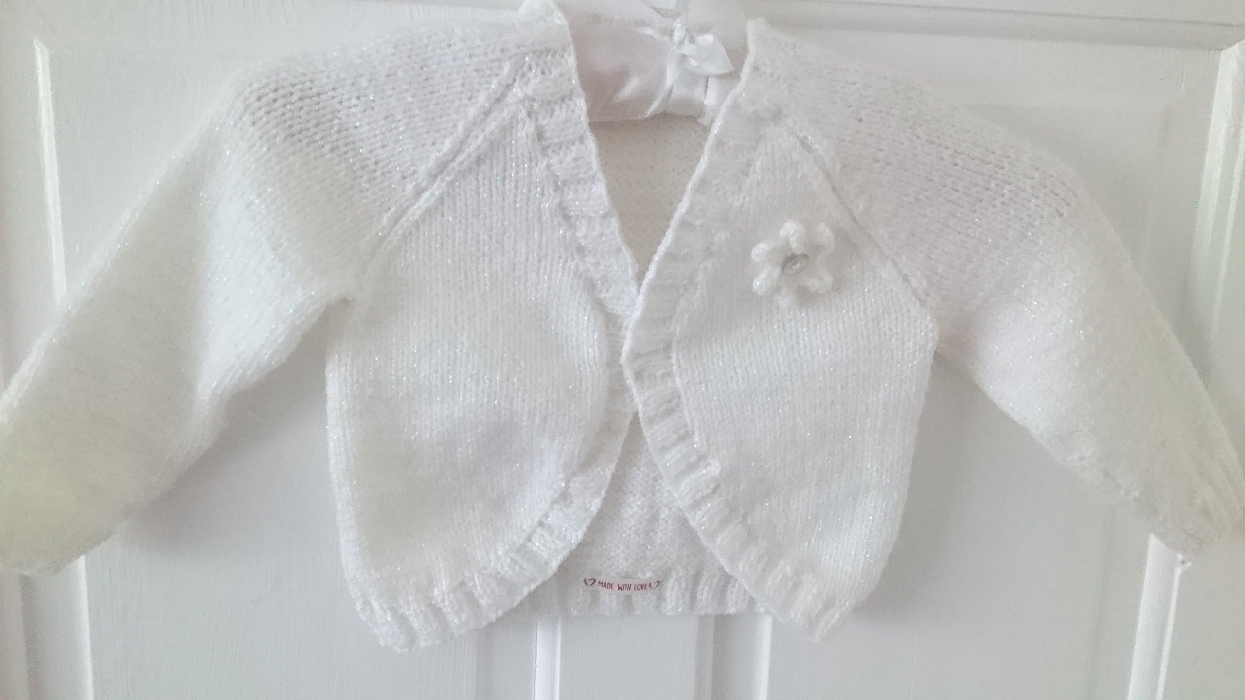 Lorenzo - age 2 - 3 yrs little girls hand knitted white bolero cardigan. Sparkle wool with knitted flower detail.