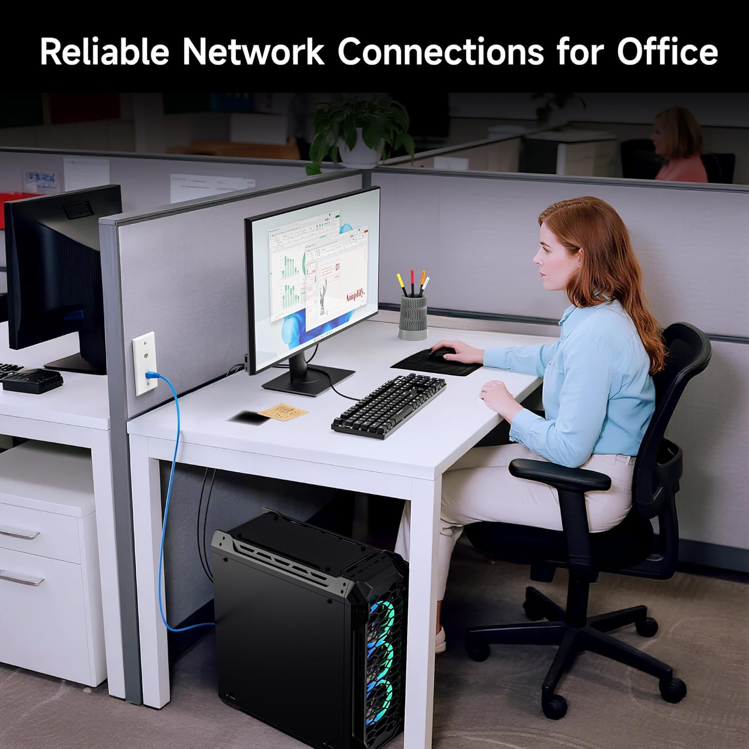 An office desk setup showing a computer connected to a wall plate with a Cat6 Keystone Jack, illustrating reliable network connections.