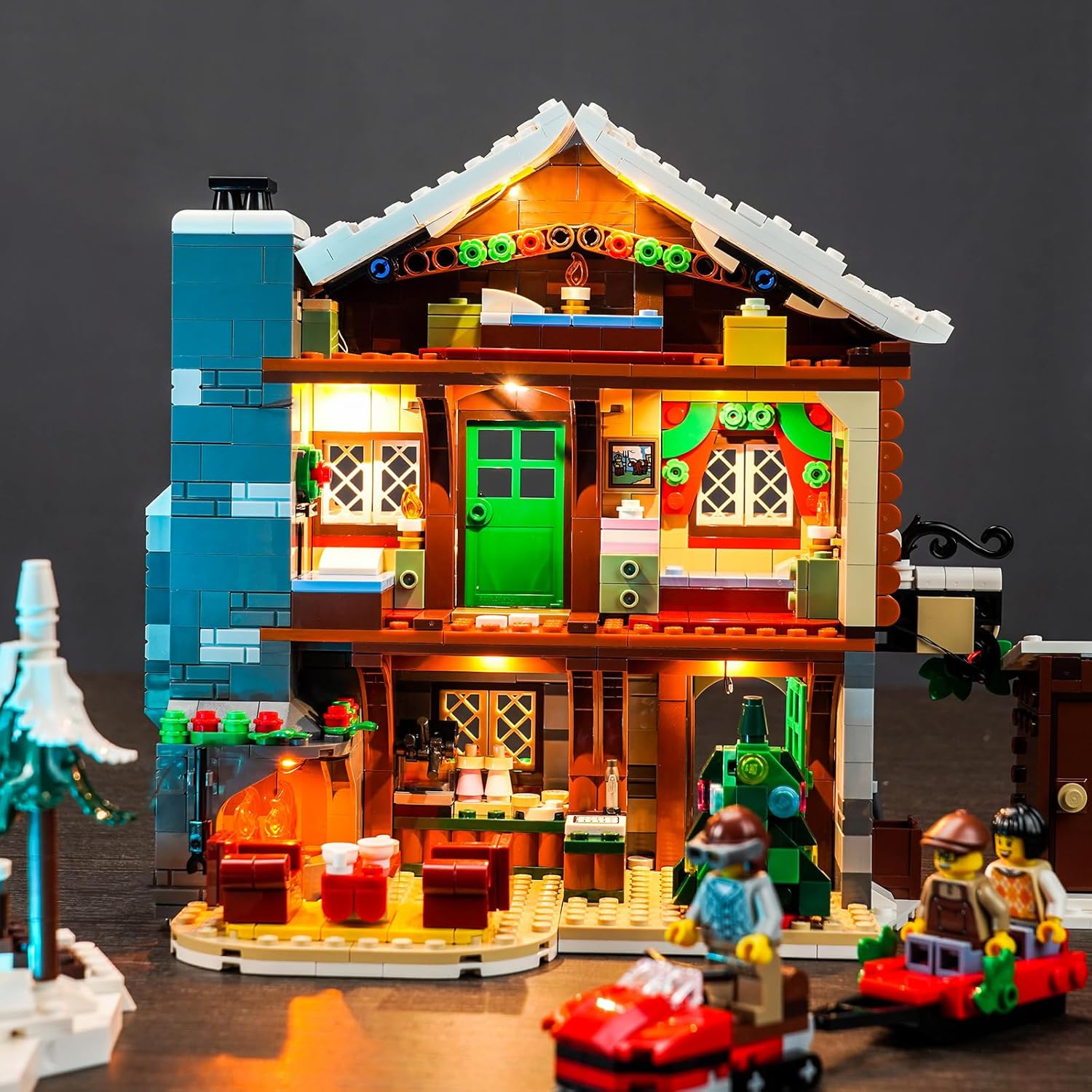 The Lego 10325 Alpine Lodge Winter Village Set fully illuminated with the BrickBling LED Lighting Kit, showcasing interior and exterior lights.