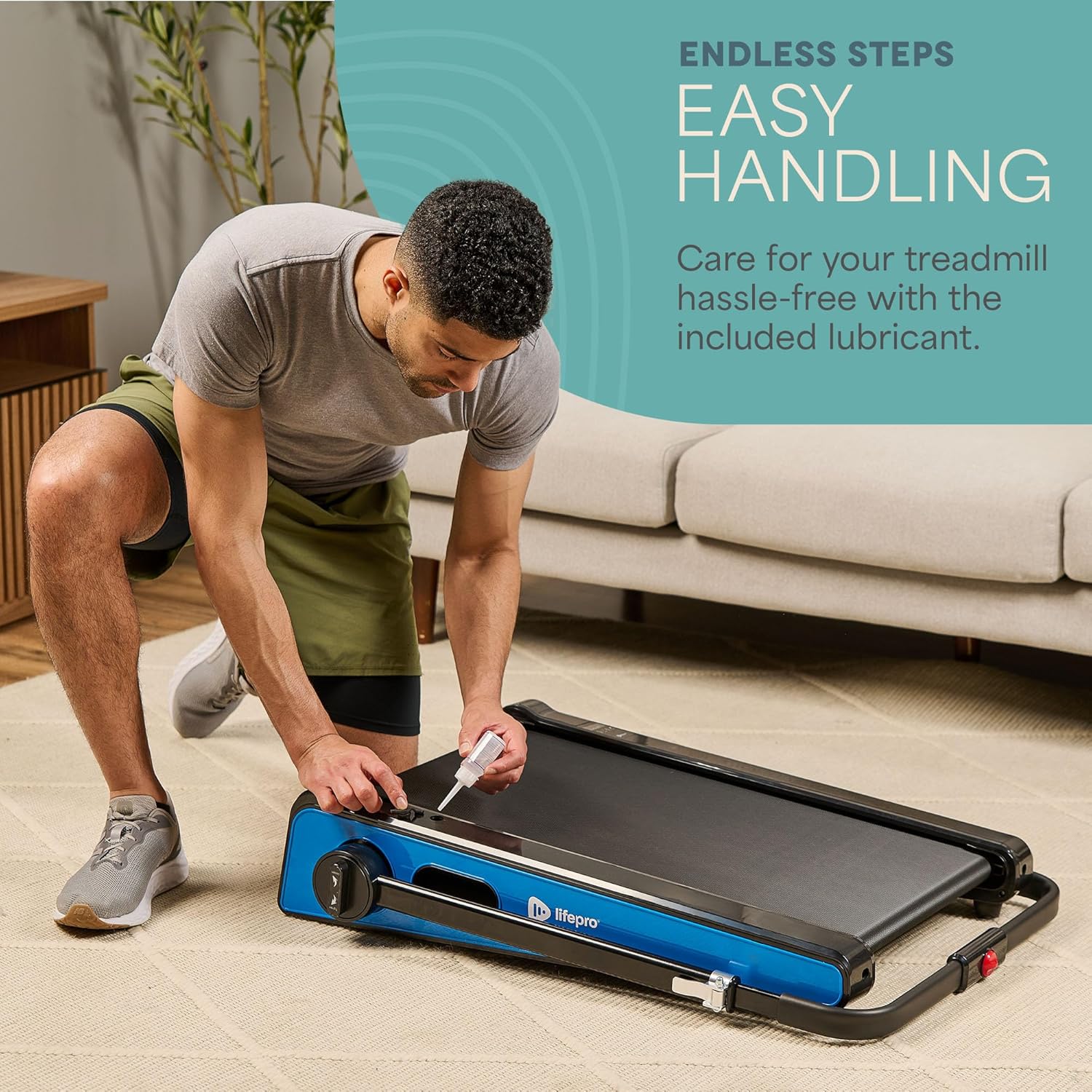 Man applying silicone oil to the walking pad belt for maintenance