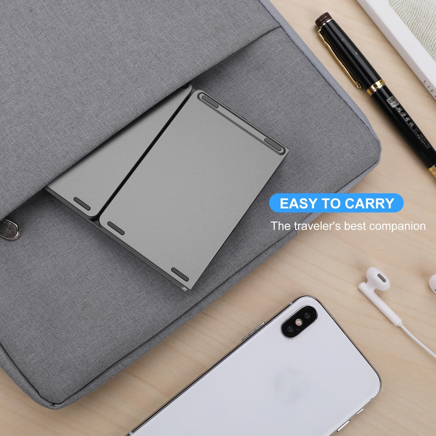 VssoPlor Foldable Bluetooth Keyboard being easily slipped into a laptop bag, demonstrating its portability.