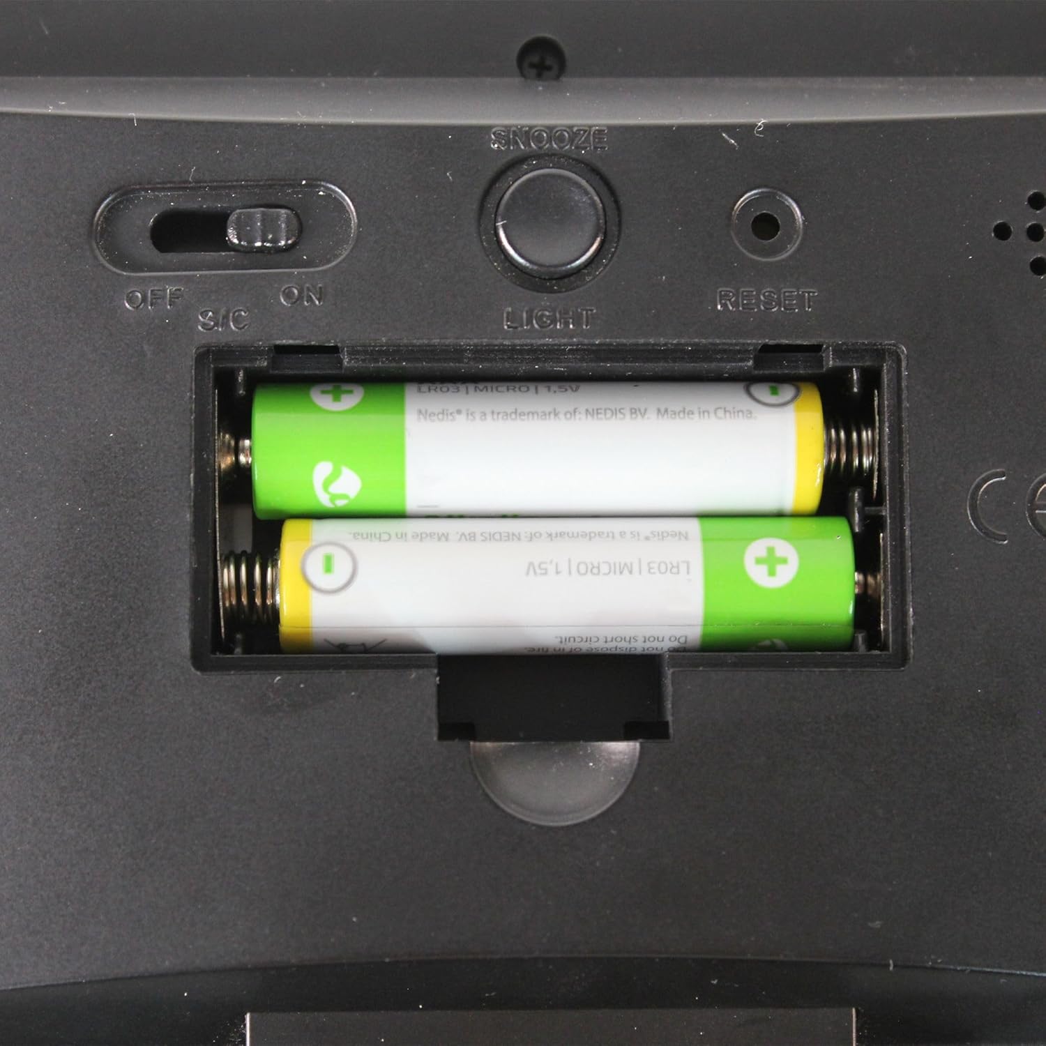 Close-up of the battery compartment on the back of the FISHTEC Weather Station S2576 with two AAA batteries inserted.