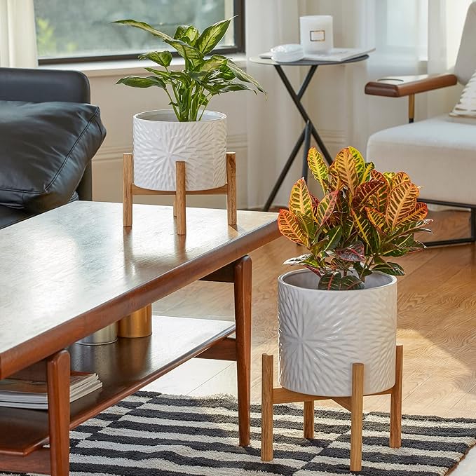 This plant pot is part of the Mid Century collection, which features sleek and minimalist designs that are perfect for contemporary spaces. The white color of this planter adds a clean and crisp look to any room, complementing a variety of decor styles. With its unique design and practical features, this plant pot is a great choice for anyone looking to add a touch of greenery to their home.