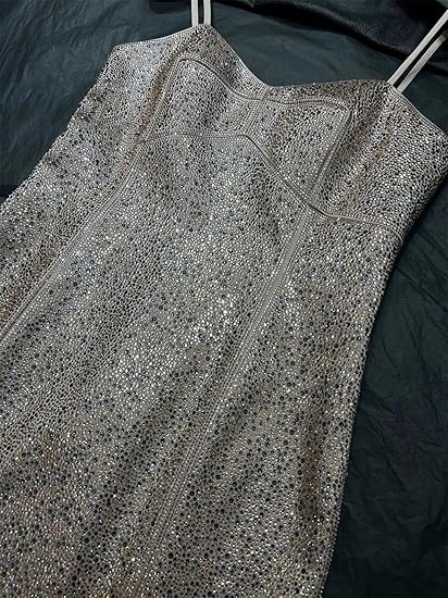 Fitted back view of slim evening gown with spaghetti straps.