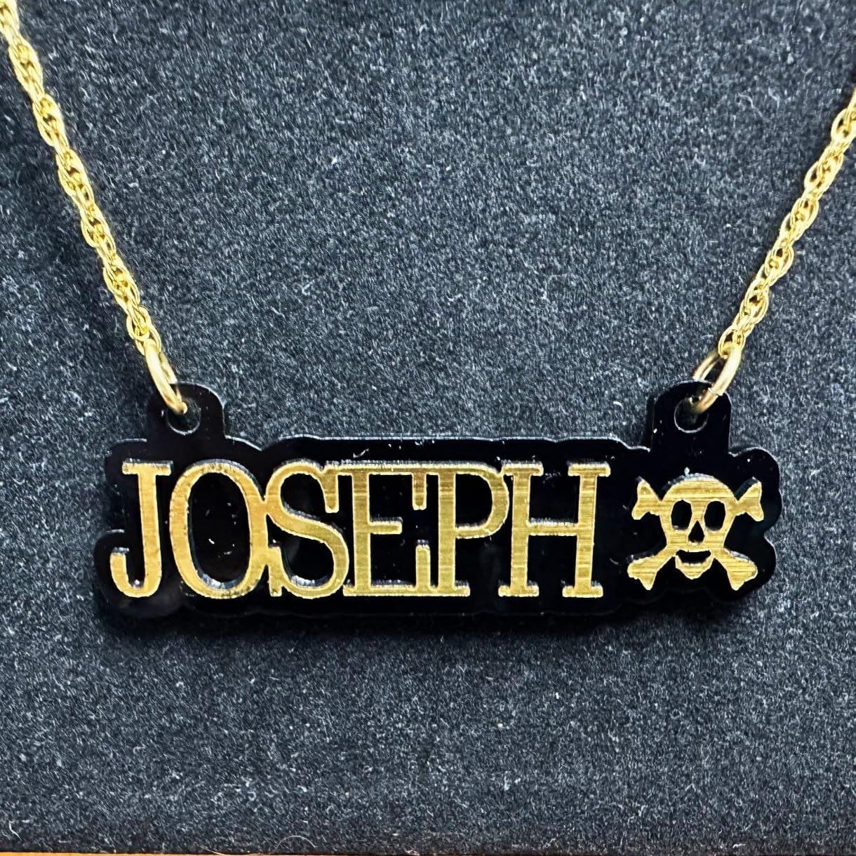 Sports Fan Player Gamer Themed Nameplate Necklace with Gold Laser Cut Letters and Pirate Skull & Bones on Black Shiny Background with Gold Chain Personalized Made to Order Custom Any Name Great Gift Idea Made in CT, USA