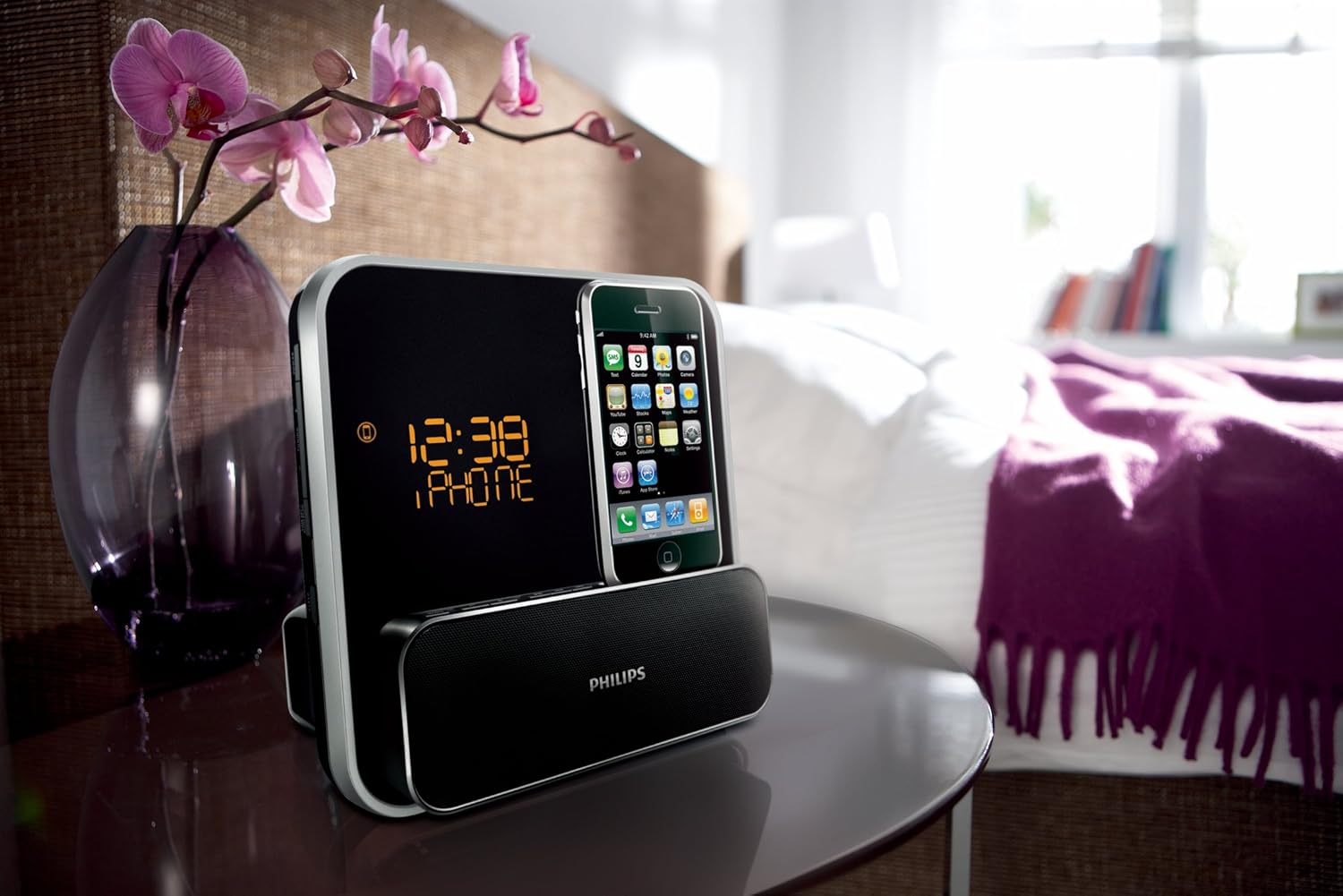 The Philips DC315/37 speaker system with its LED display showing the time and 'IPHONE', highlighting its clock and alarm features.
