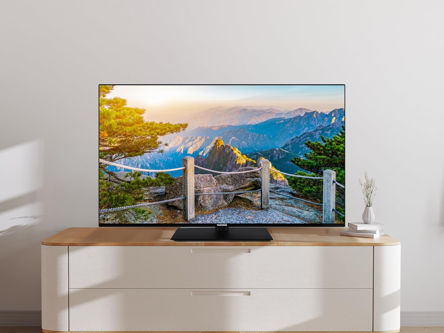 TELEFUNKEN 50-inch Ultra HD Smart TV placed on a TV stand in a living room