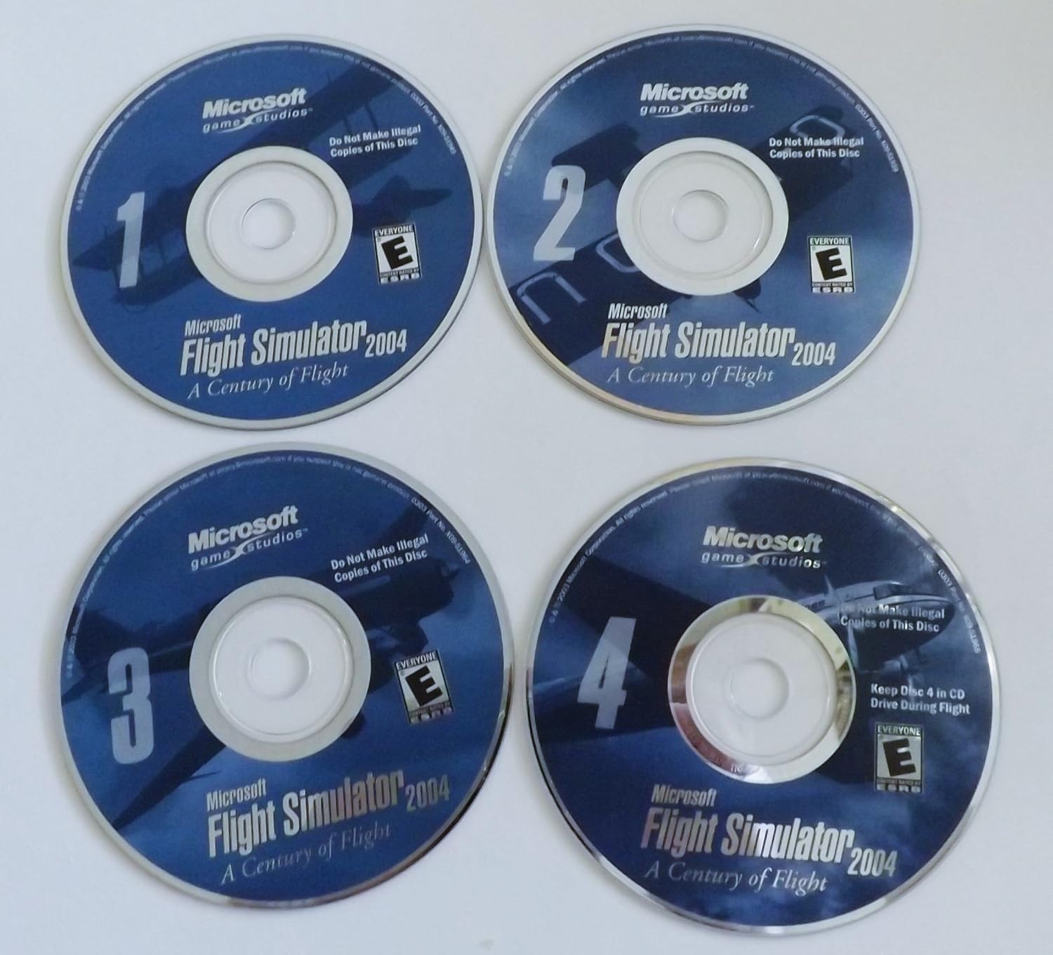 Four Microsoft Flight Simulator 2004 game discs