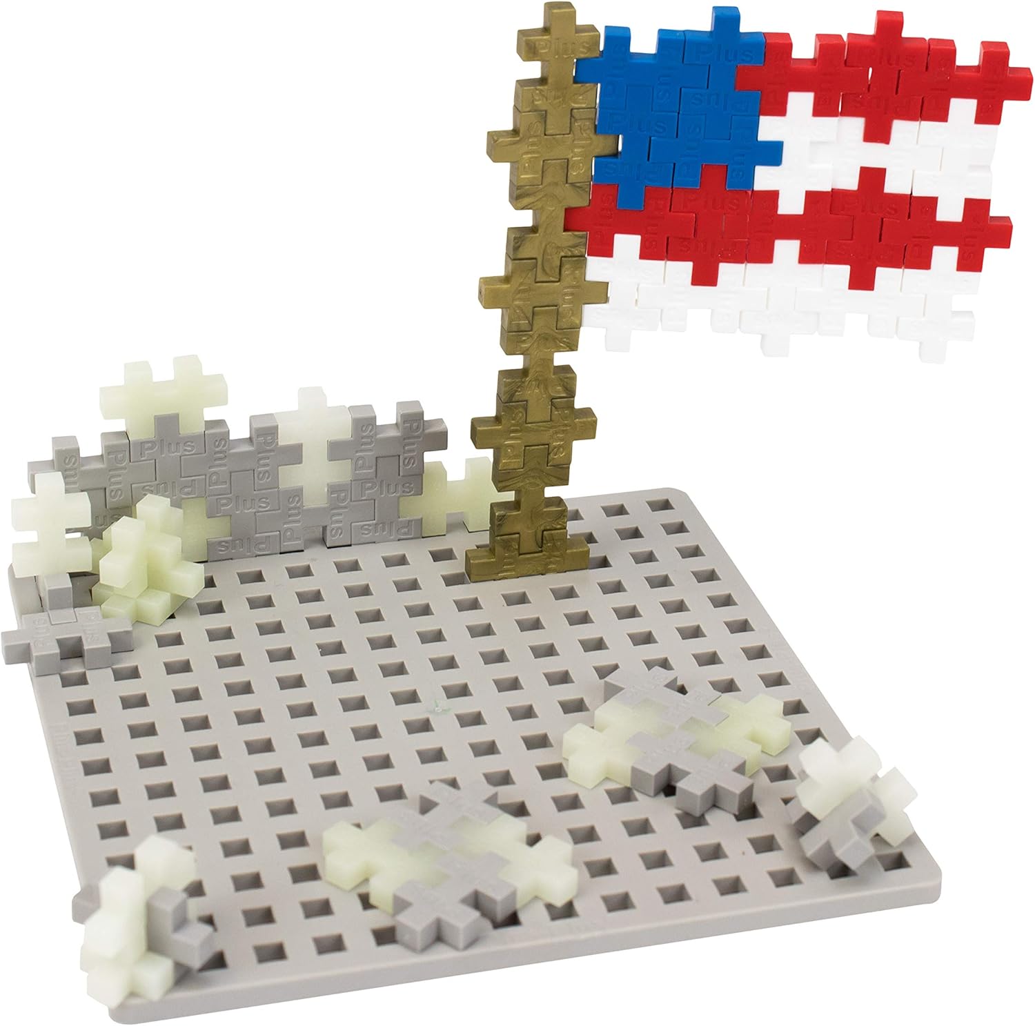 Contents of the PLUS PLUS Baseplate Builder Moon set, showing a gray baseplate and various Plus-Plus pieces, including an assembled flag and astronaut.