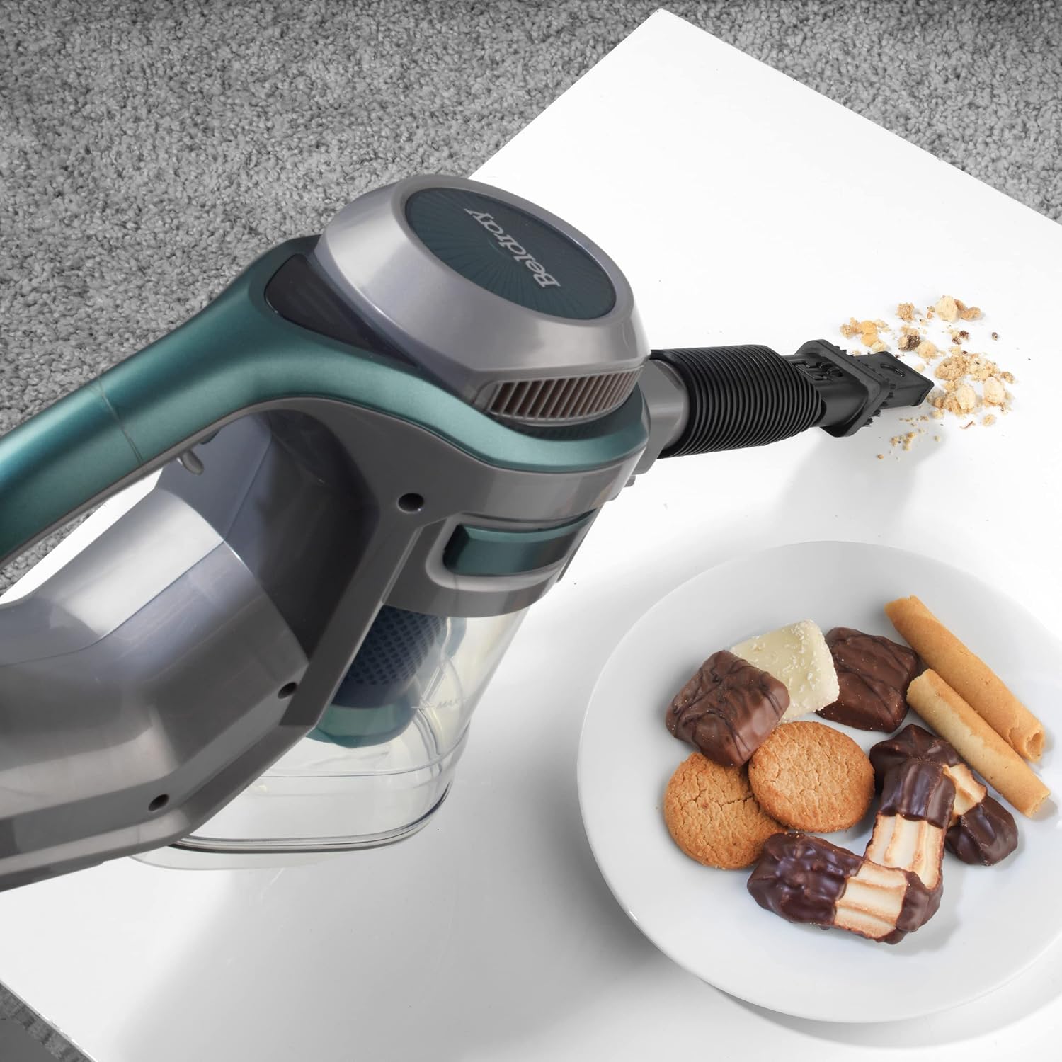 Handheld vacuum cleaning crumbs from a table