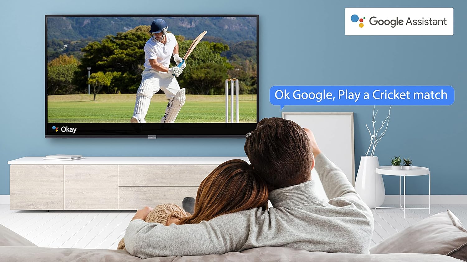 Couple watching TV and using Google Assistant voice command