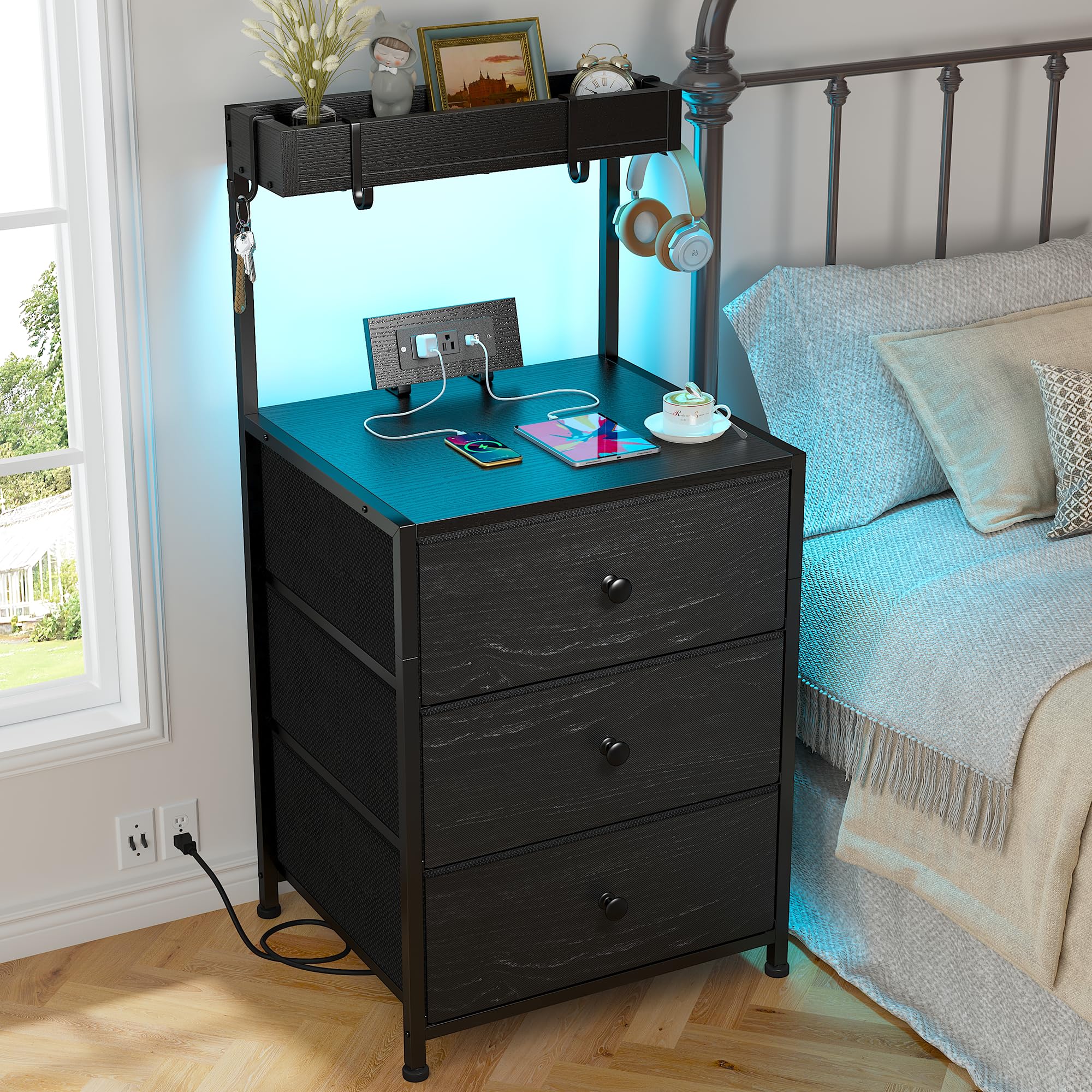 EnHomee Tall Nightstand in black with LED lights on, showing the charging station and three fabric drawers.
