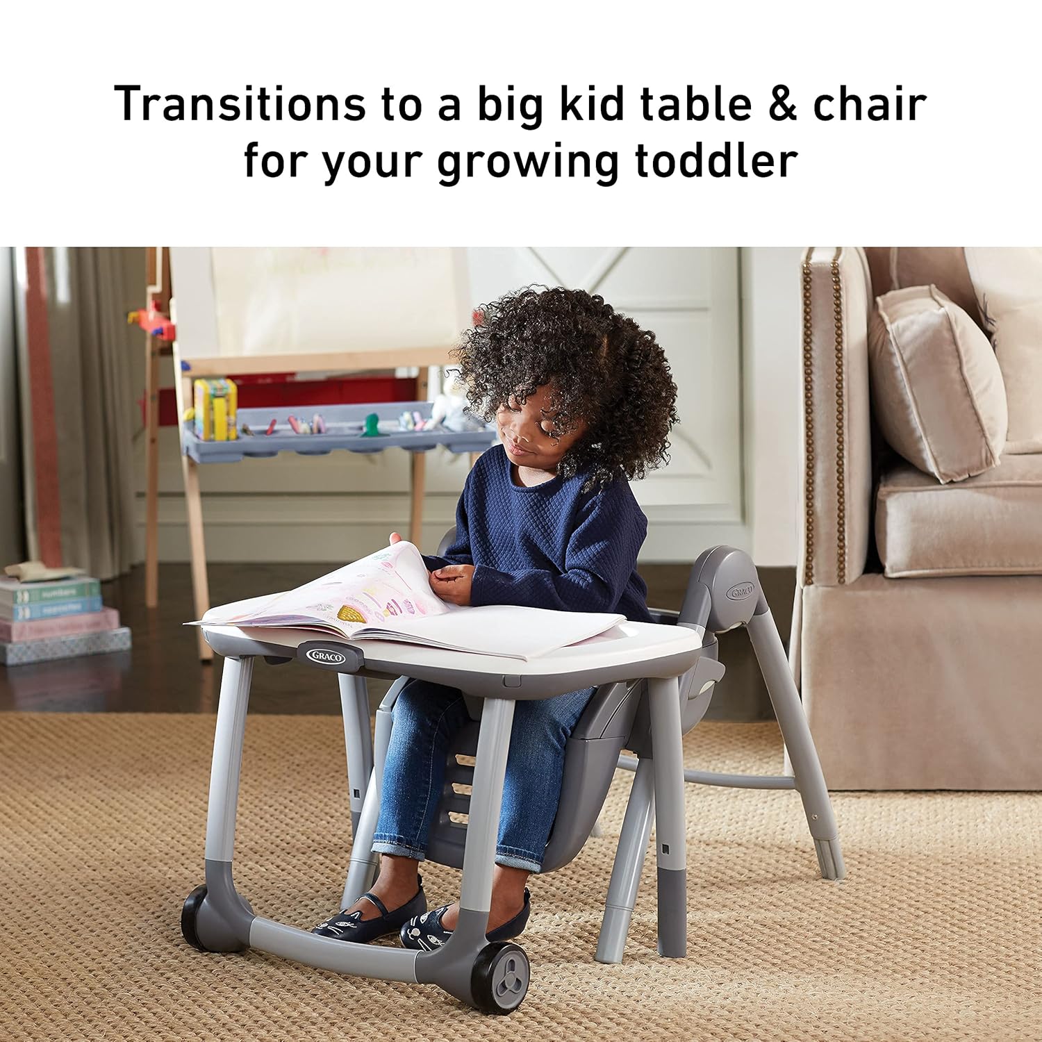 A toddler sitting at a small table and chair set, converted from the Graco high chair, engaged in an activity.