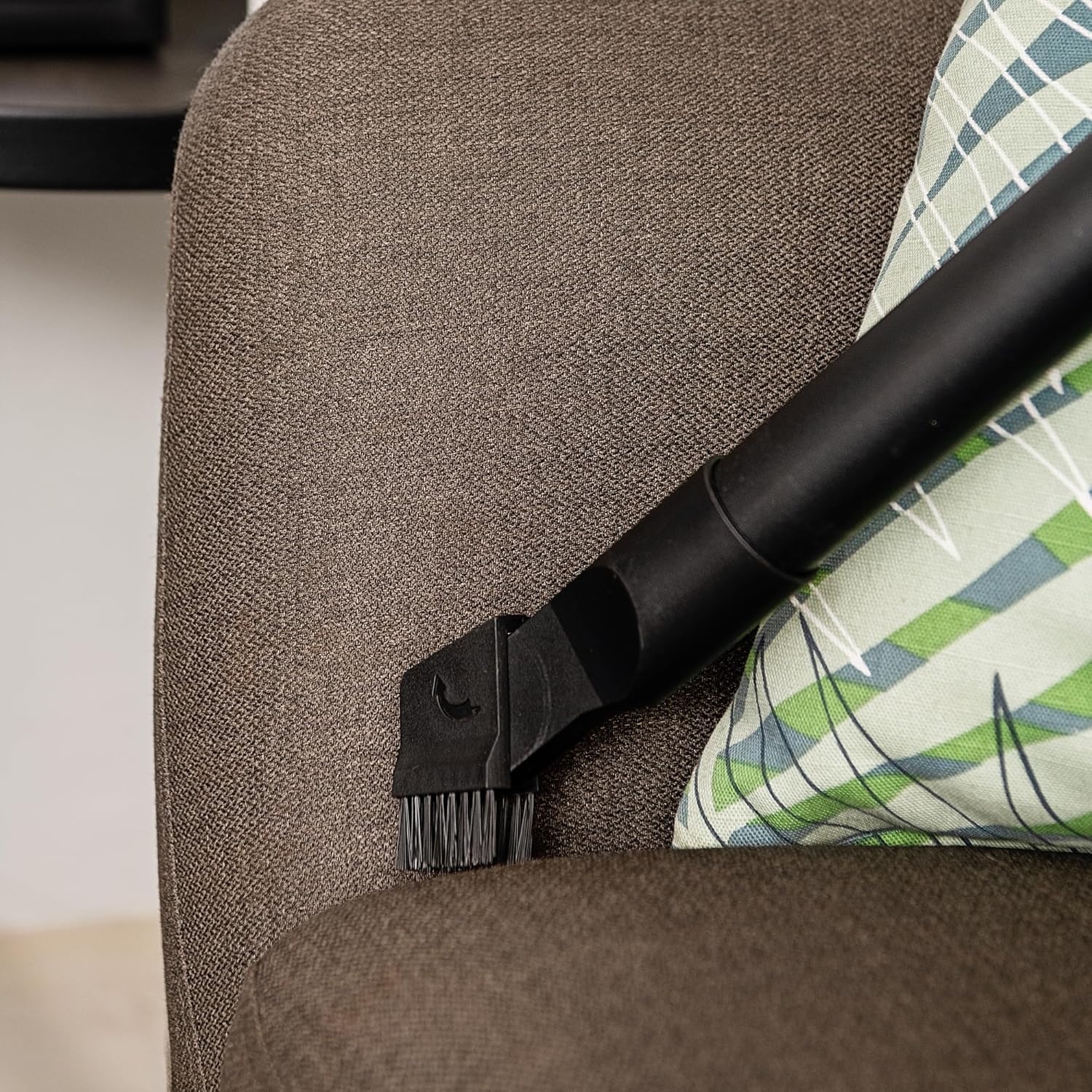 Crevice tool attachment cleaning upholstery