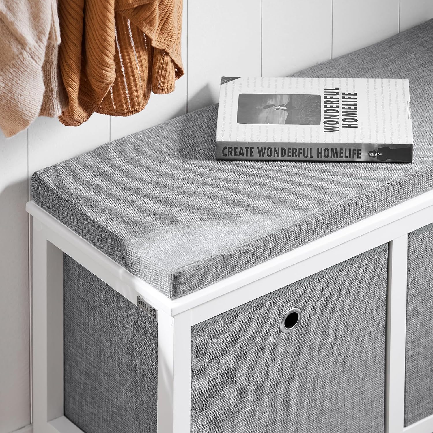 Close-up of the grey seat cushion texture on the white bench